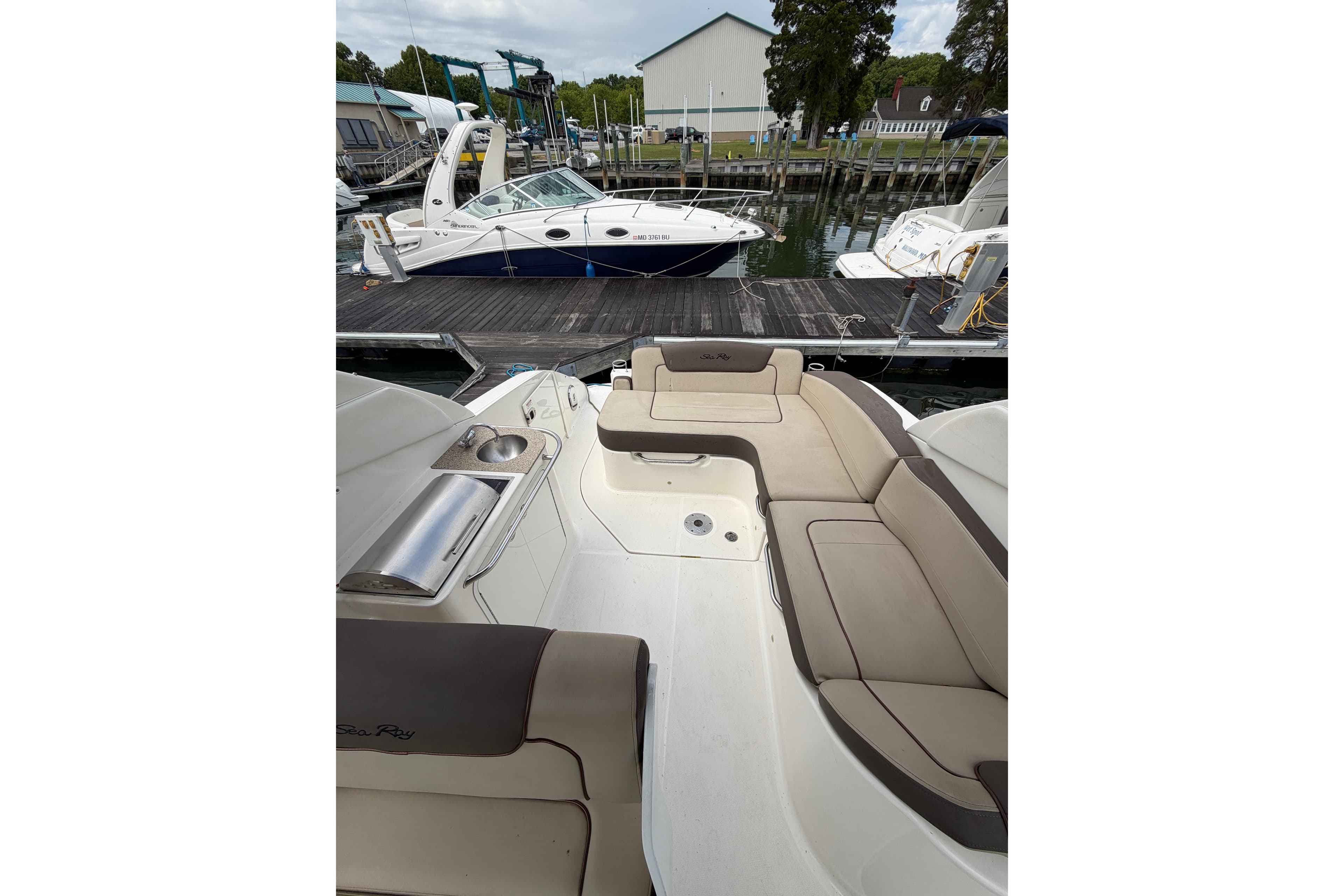 2015 Sea Ray 280 Sunrunner boat docked, featuring spacious seating and sleek design.
