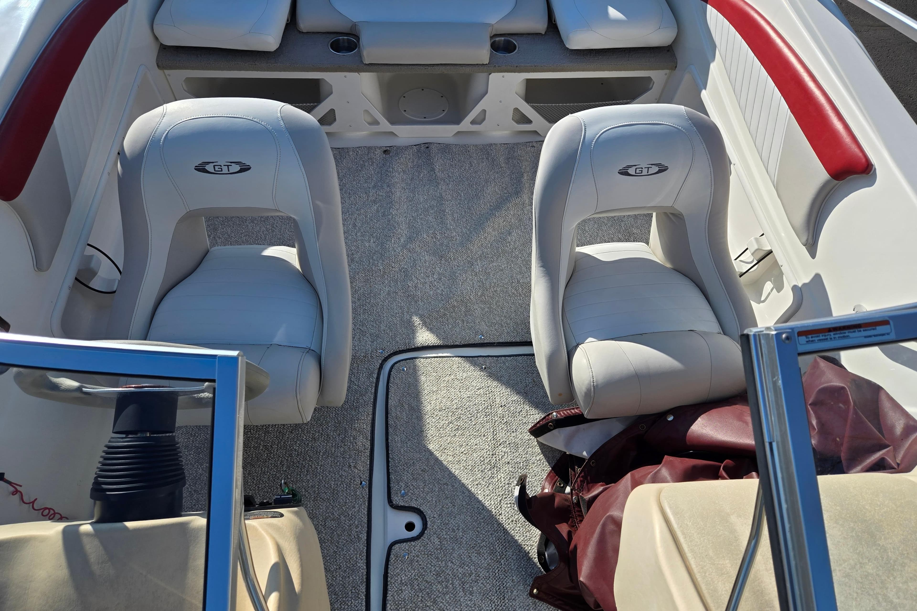 2007 Glastron GT 205 Ski & Fish boat interior with white seats and red accents.