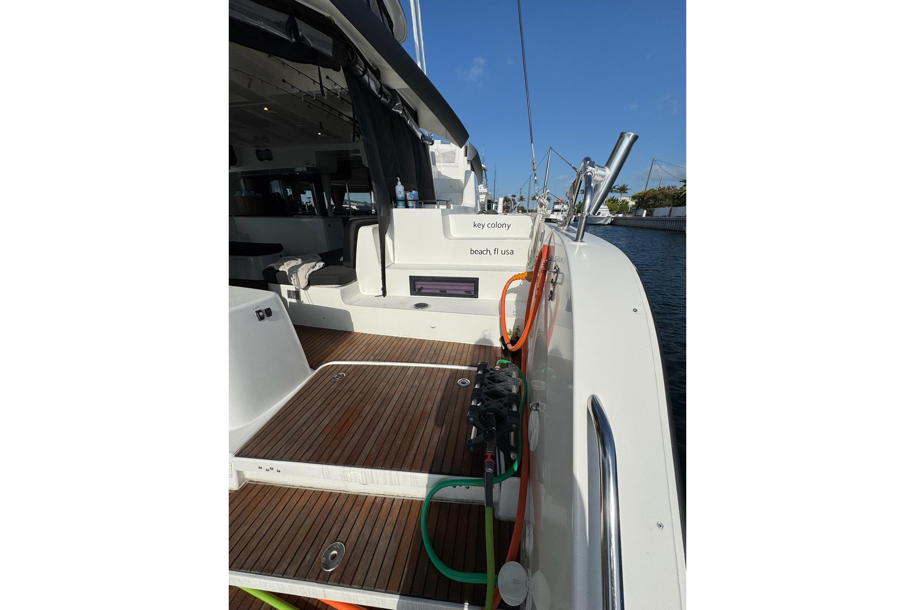 2020 Lagoon 46 yacht deck with wooden flooring and marina view.