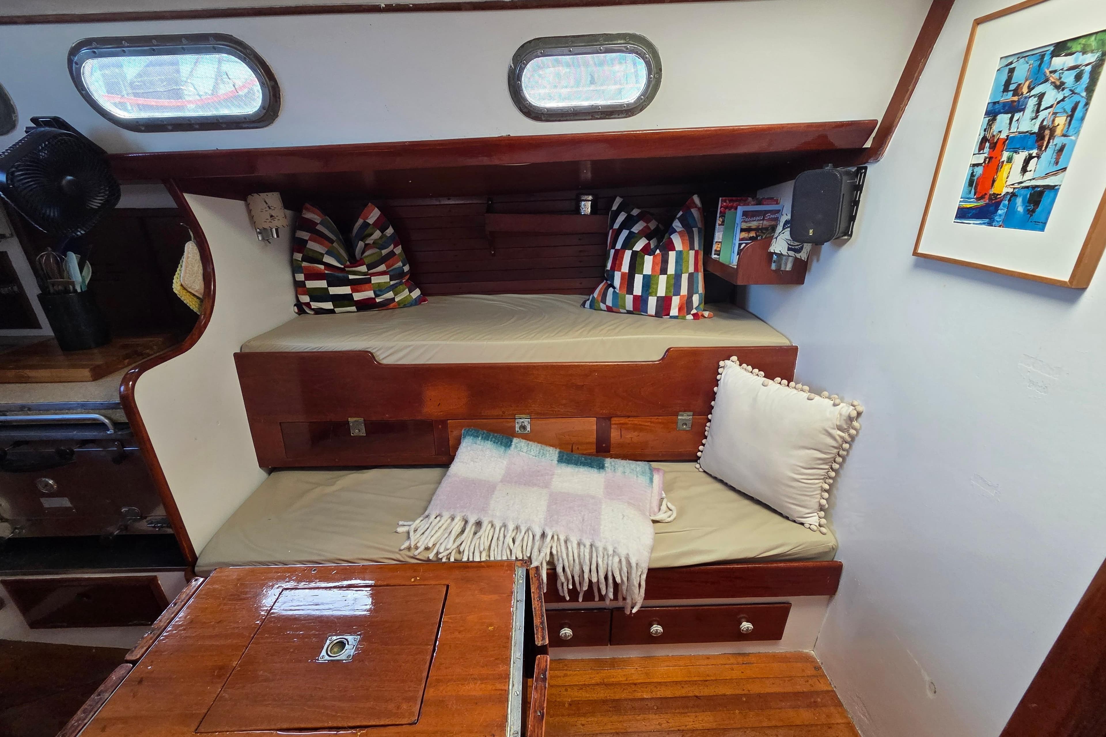Interior of a 1961 Hinckley Bermuda 40 sailboat with cozy seating and colorful decor.
