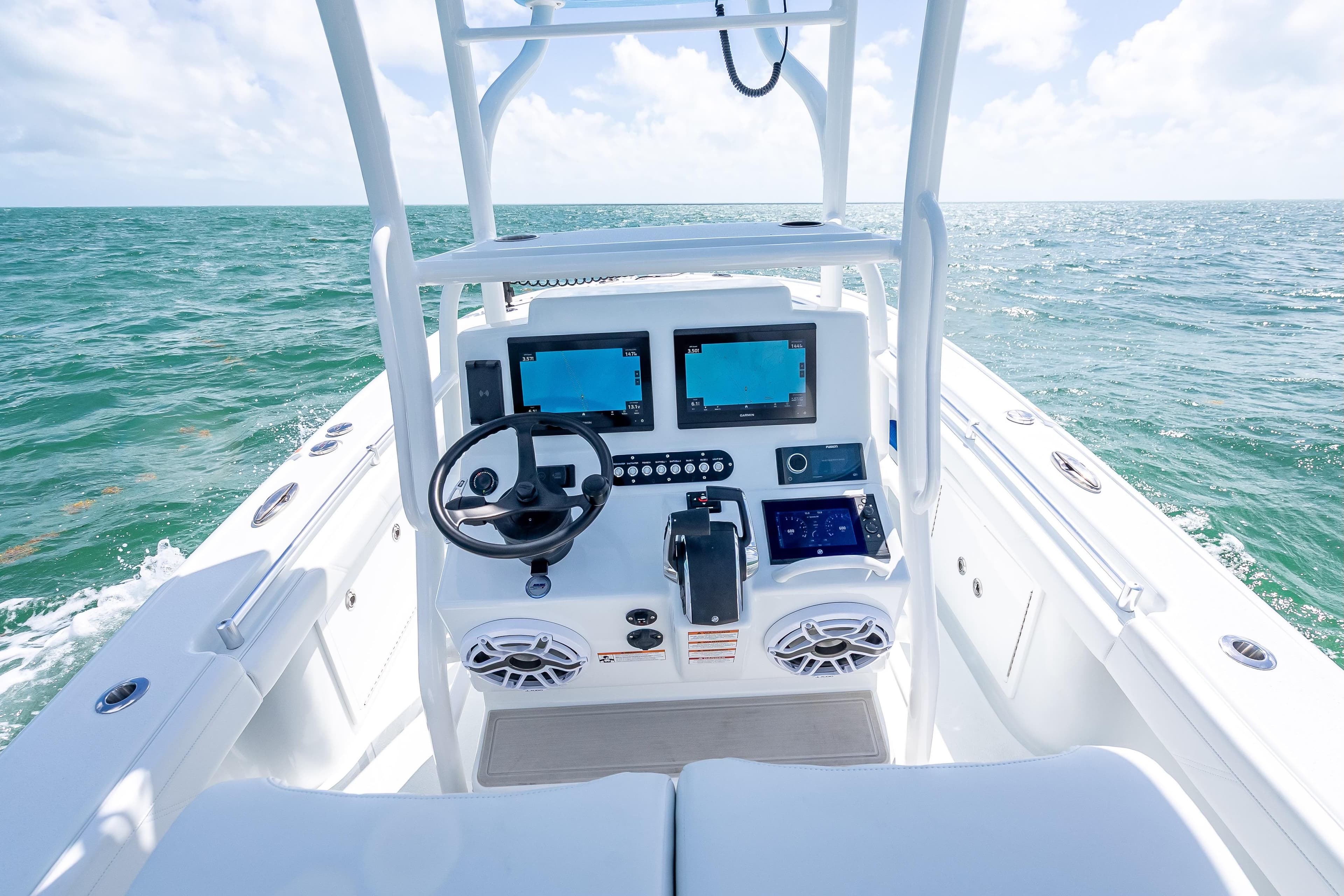 2026 Yellowfin 26 Hybrid boat dashboard with ocean view, featuring modern navigation equipment.