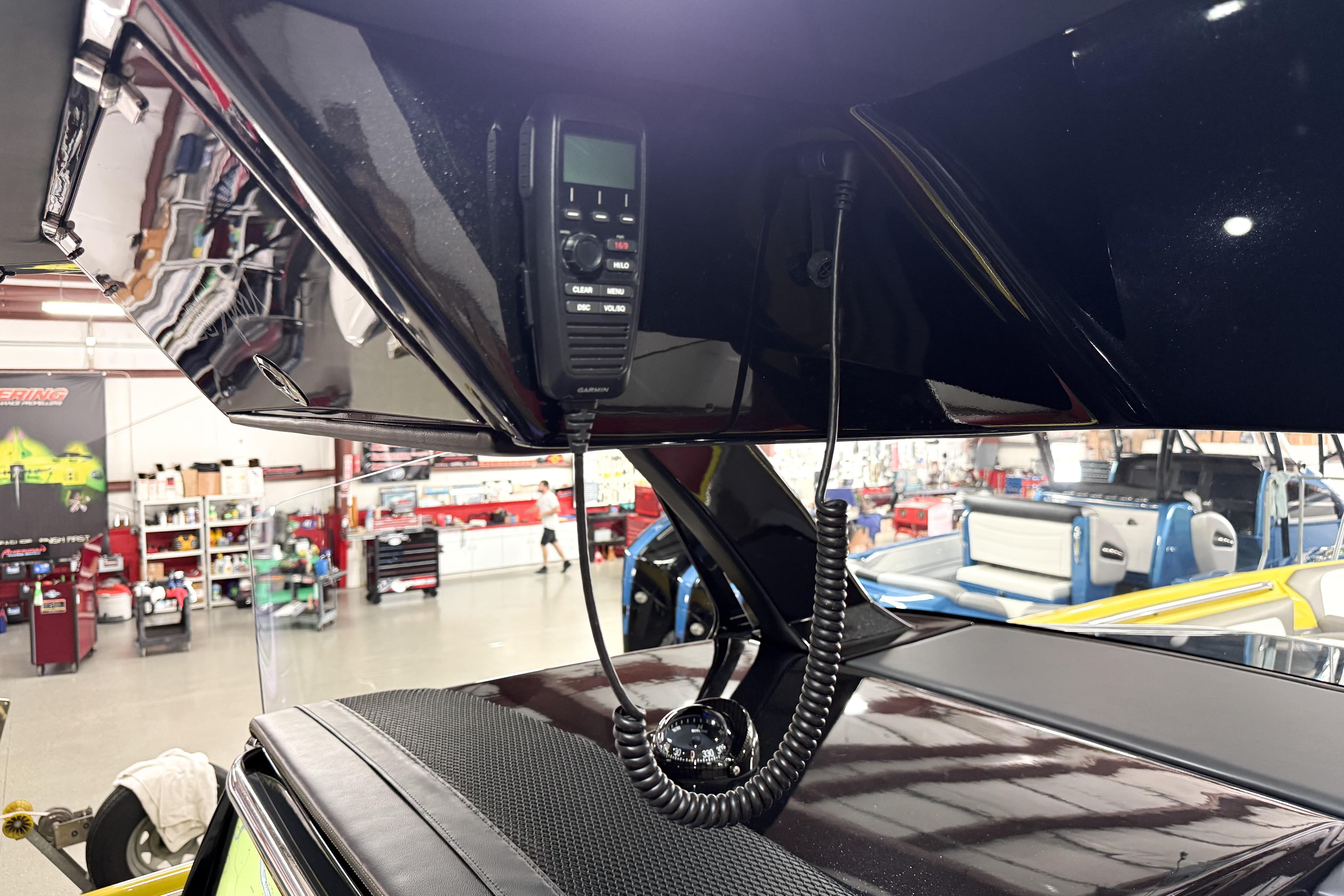 Interior of 2021 Nor-Tech 450 Sport boat with communication equipment in a workshop.