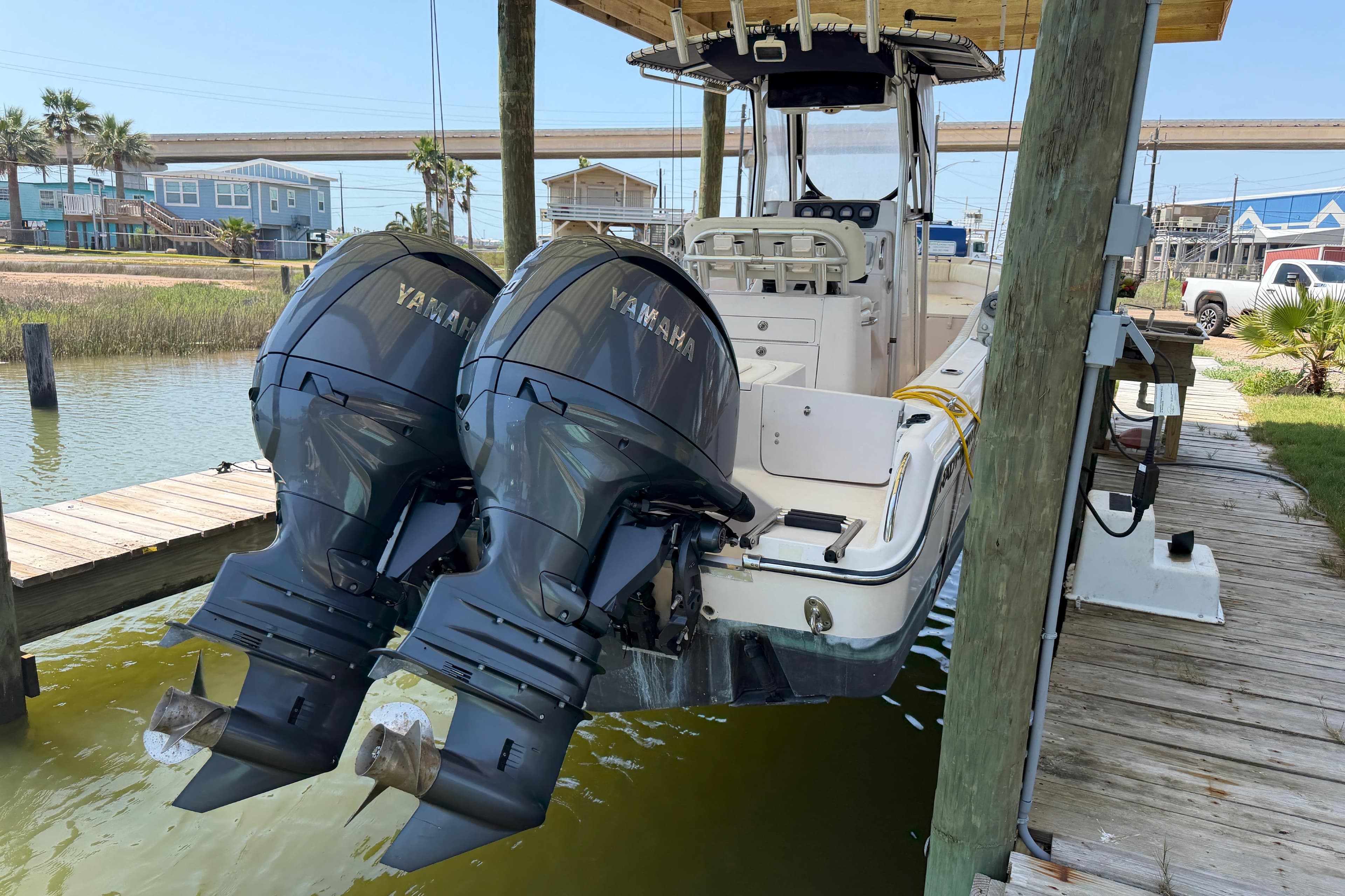 2004 Grady-White Advance 257 boat with twin Yamaha outboard motors docked.