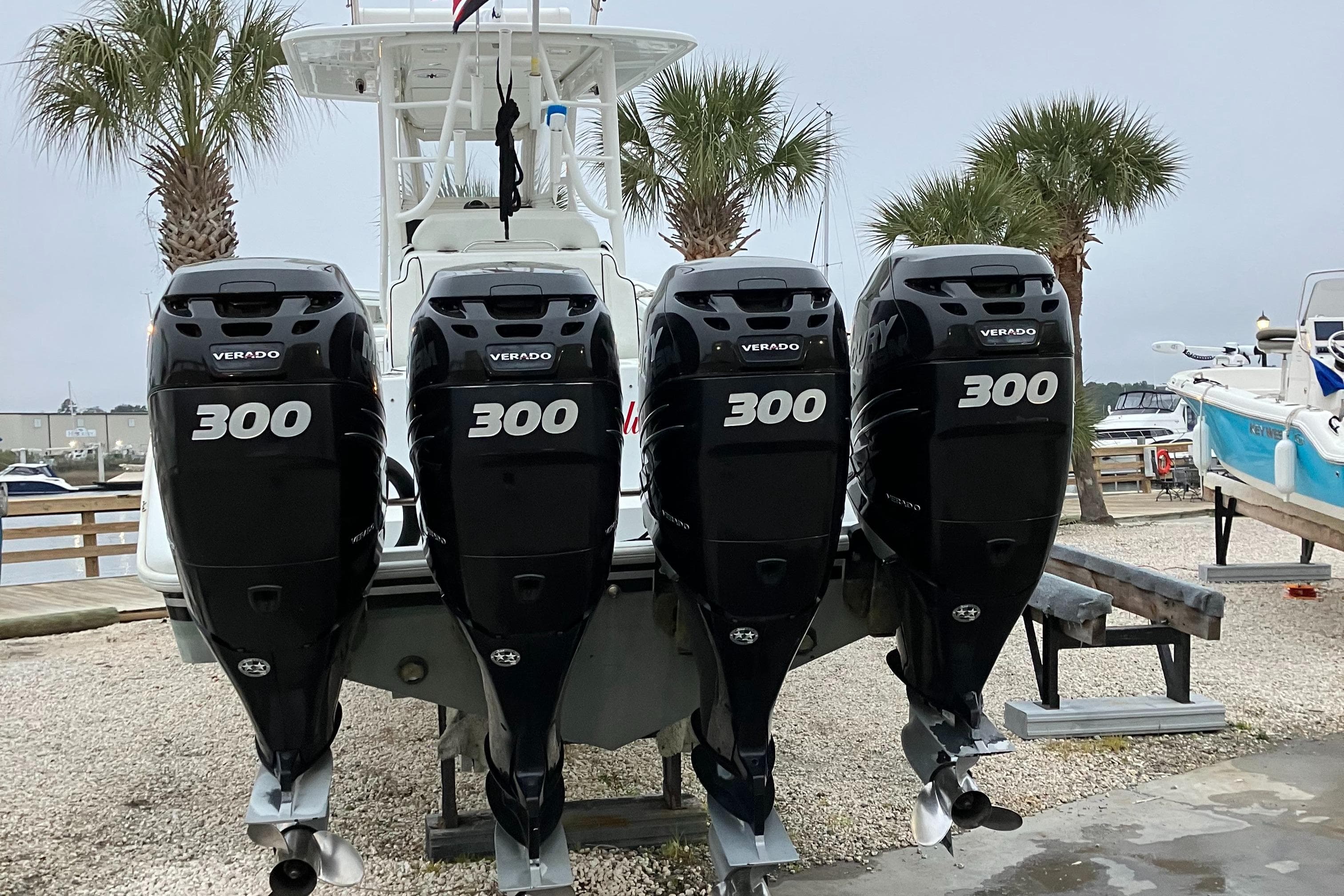 2007 Yellowfin 36 boat with four 300 horsepower outboard engines, docked near palm trees.