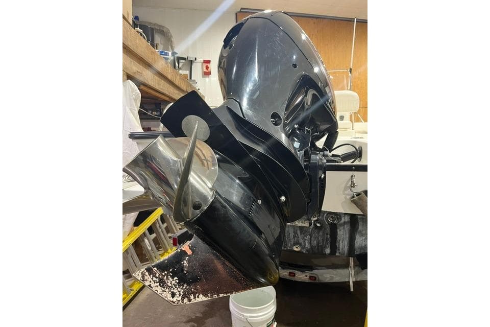 2012 Boston Whaler 190 Montauk outboard motor in a workshop setting.