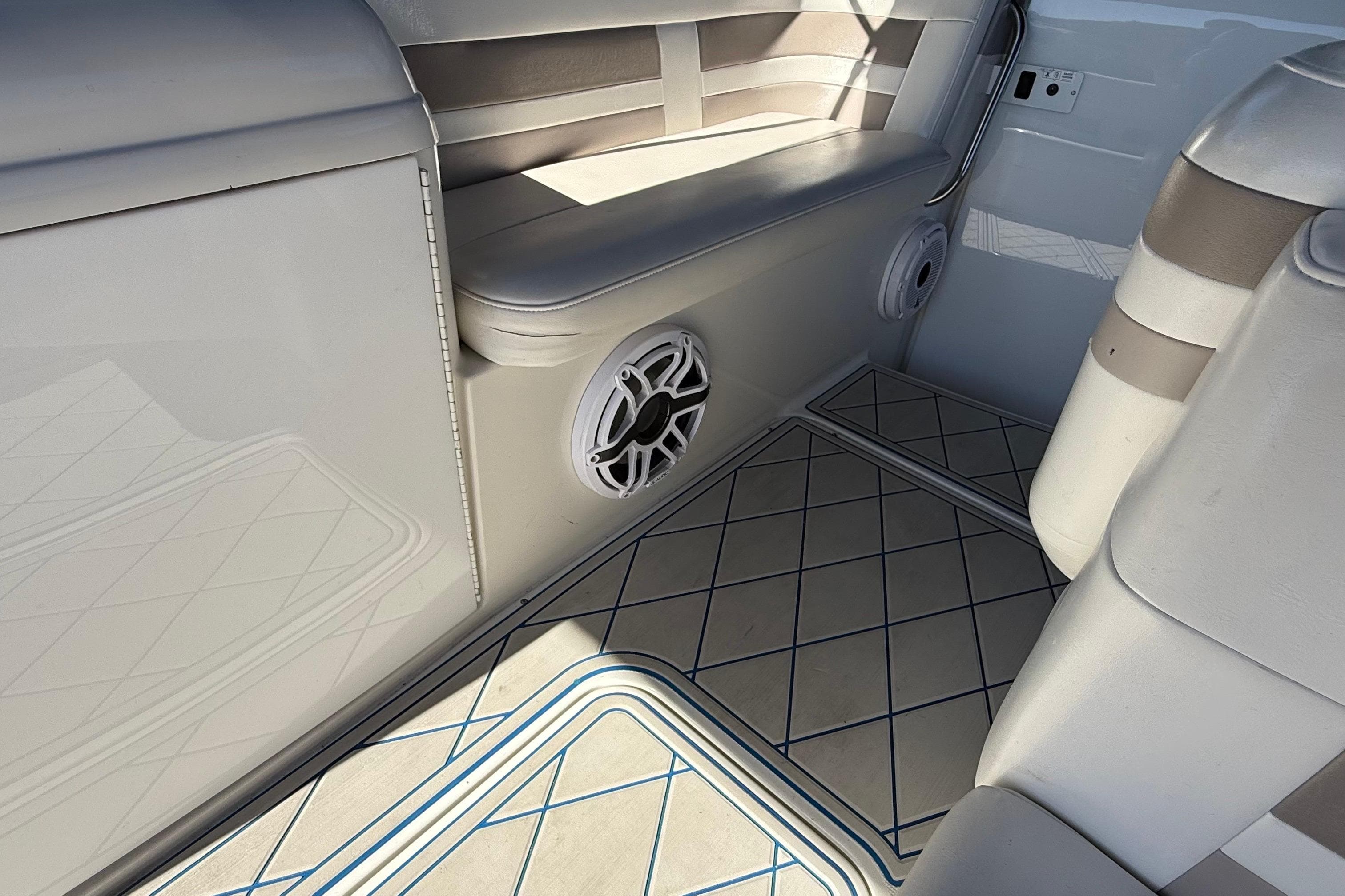 Interior of 1999 Formula 280 Sun Sport boat with seating and speaker.