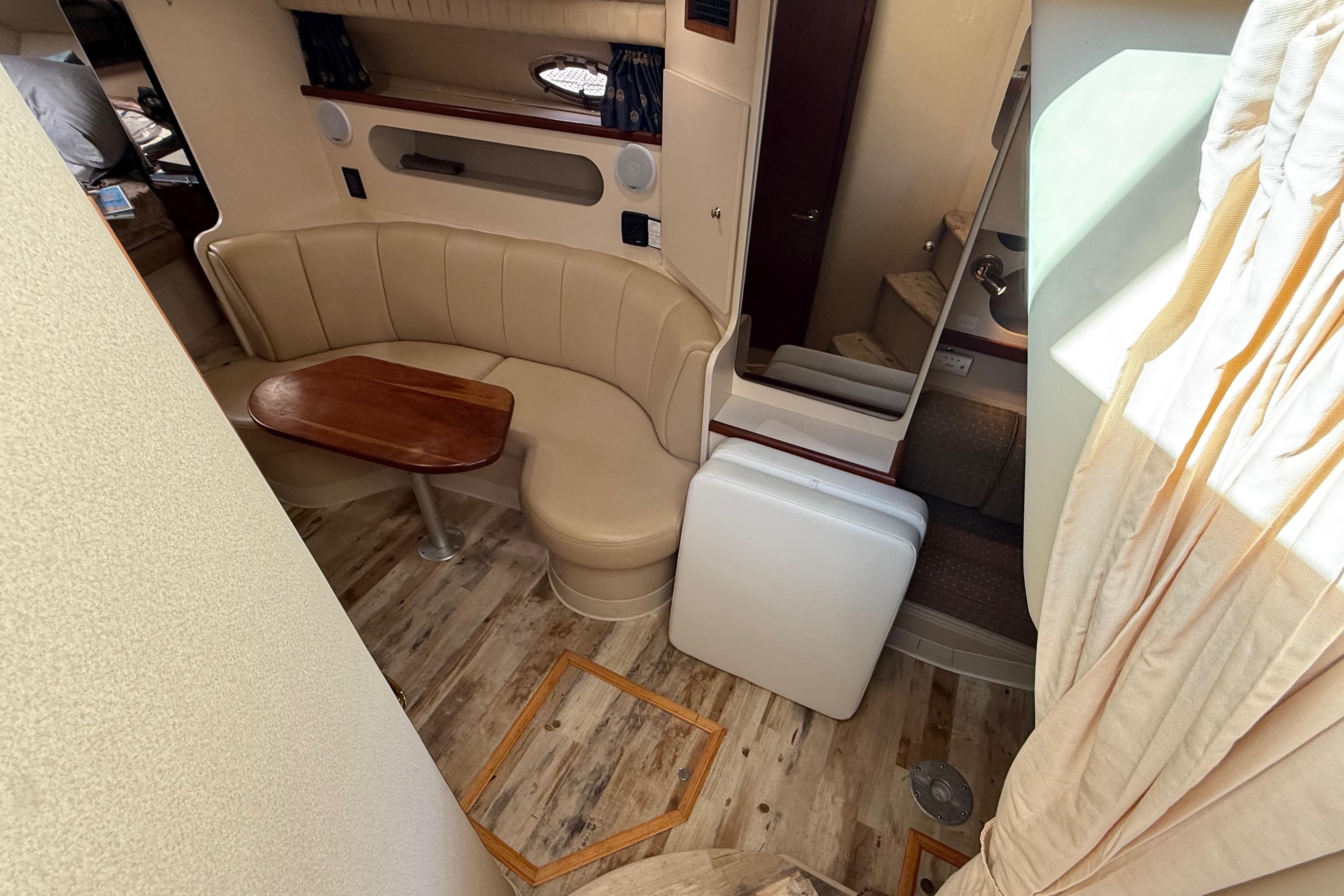 Interior of 2003 Cruisers Yachts 3075 Express with seating and wooden table.