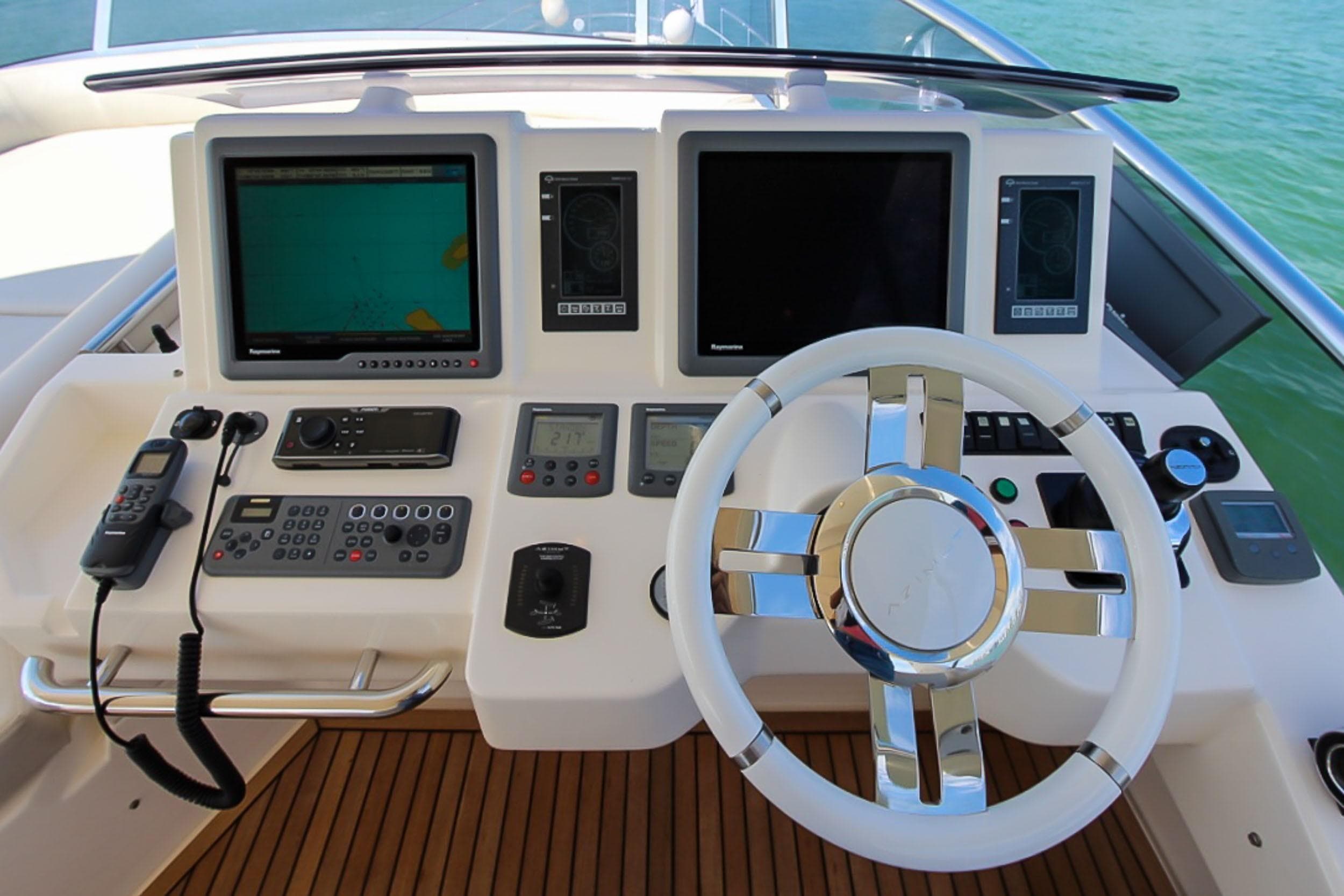 Cockpit of 2011 Azimut 70 yacht with modern navigation equipment and steering wheel.