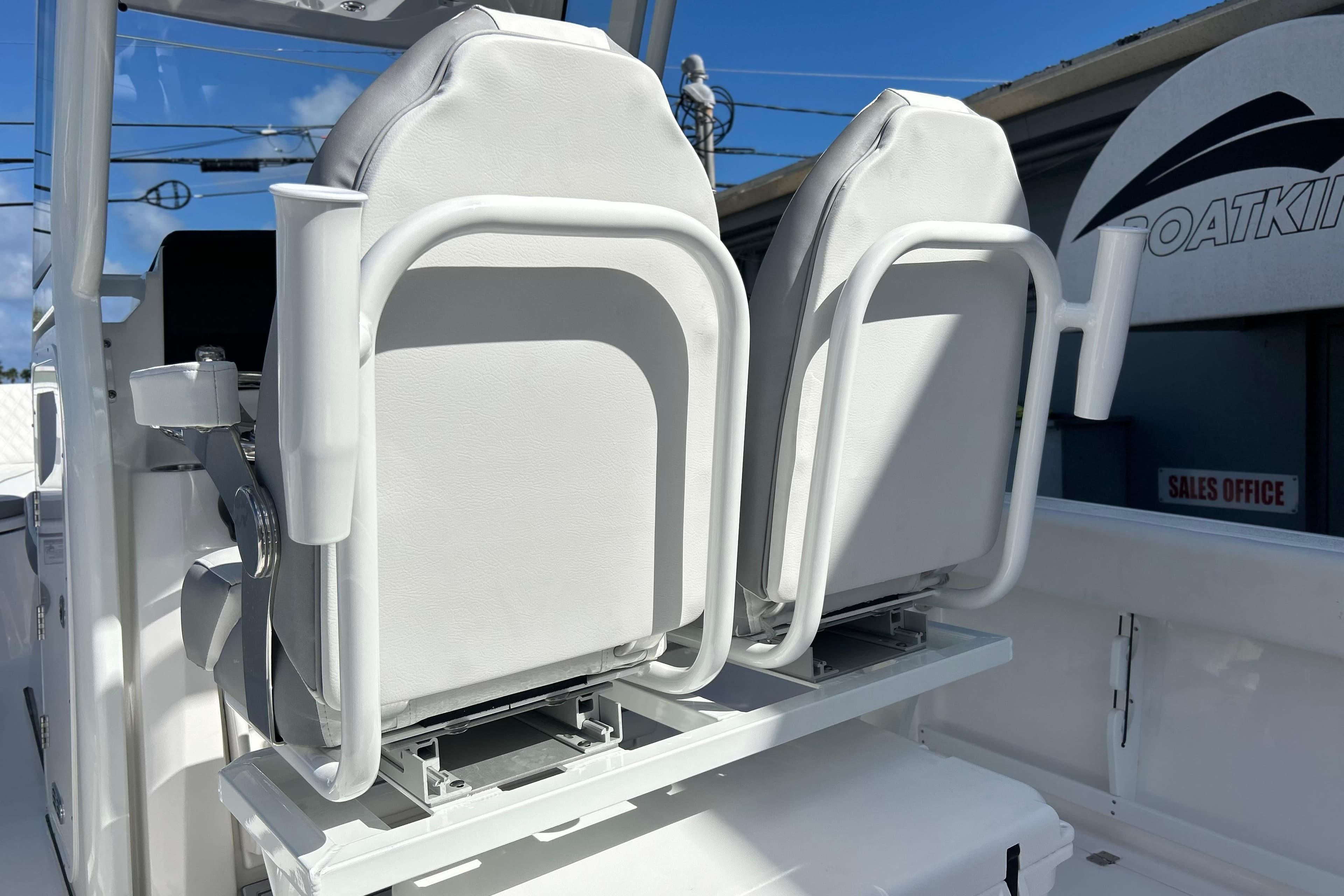 2026 Sea Fox 268 Commander boat seats, white upholstery, outdoor setting.
