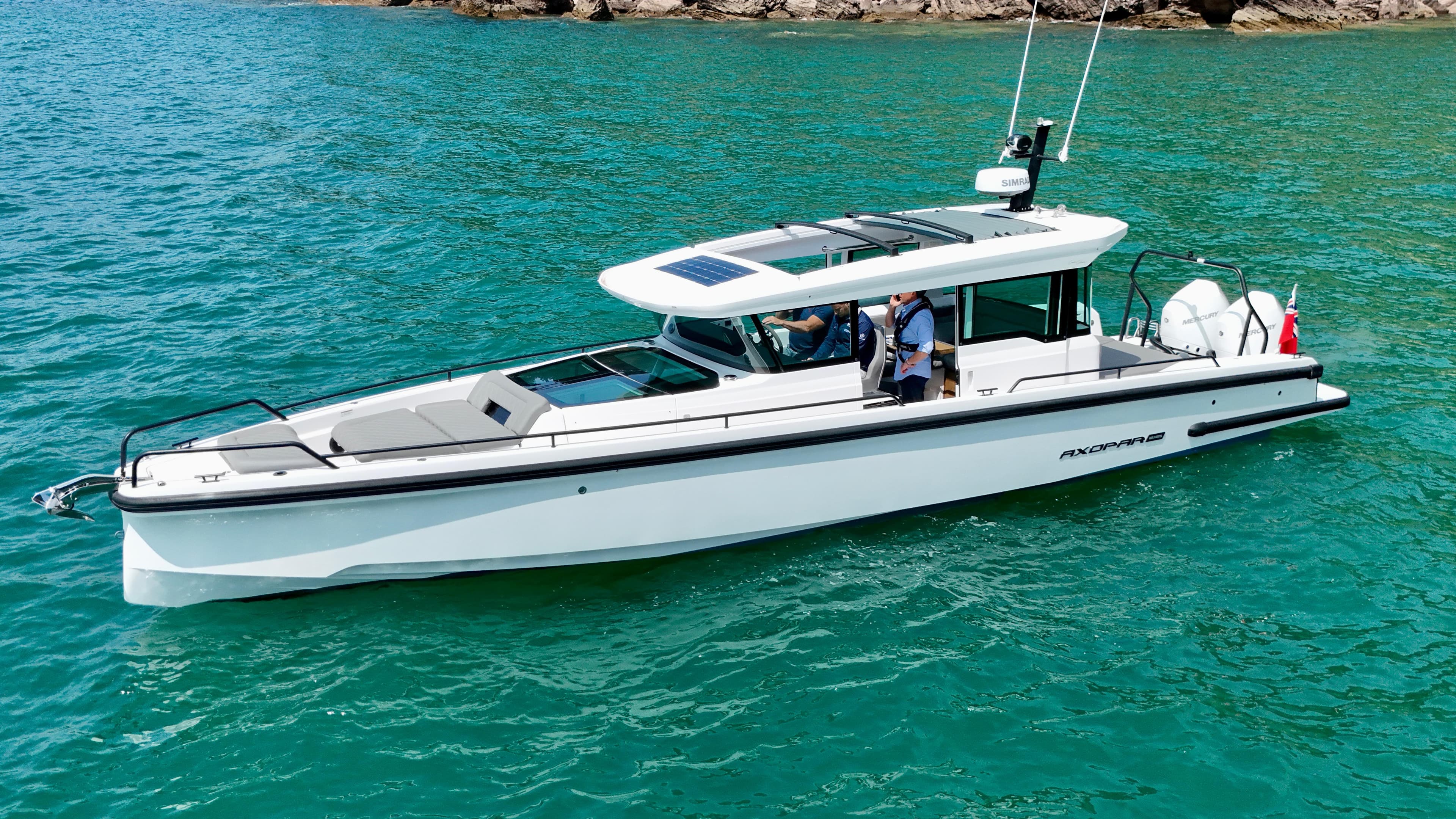 2020 Axopar 37 Cross Cabin boat on turquoise water, featuring multi-storage and JPO joystick.