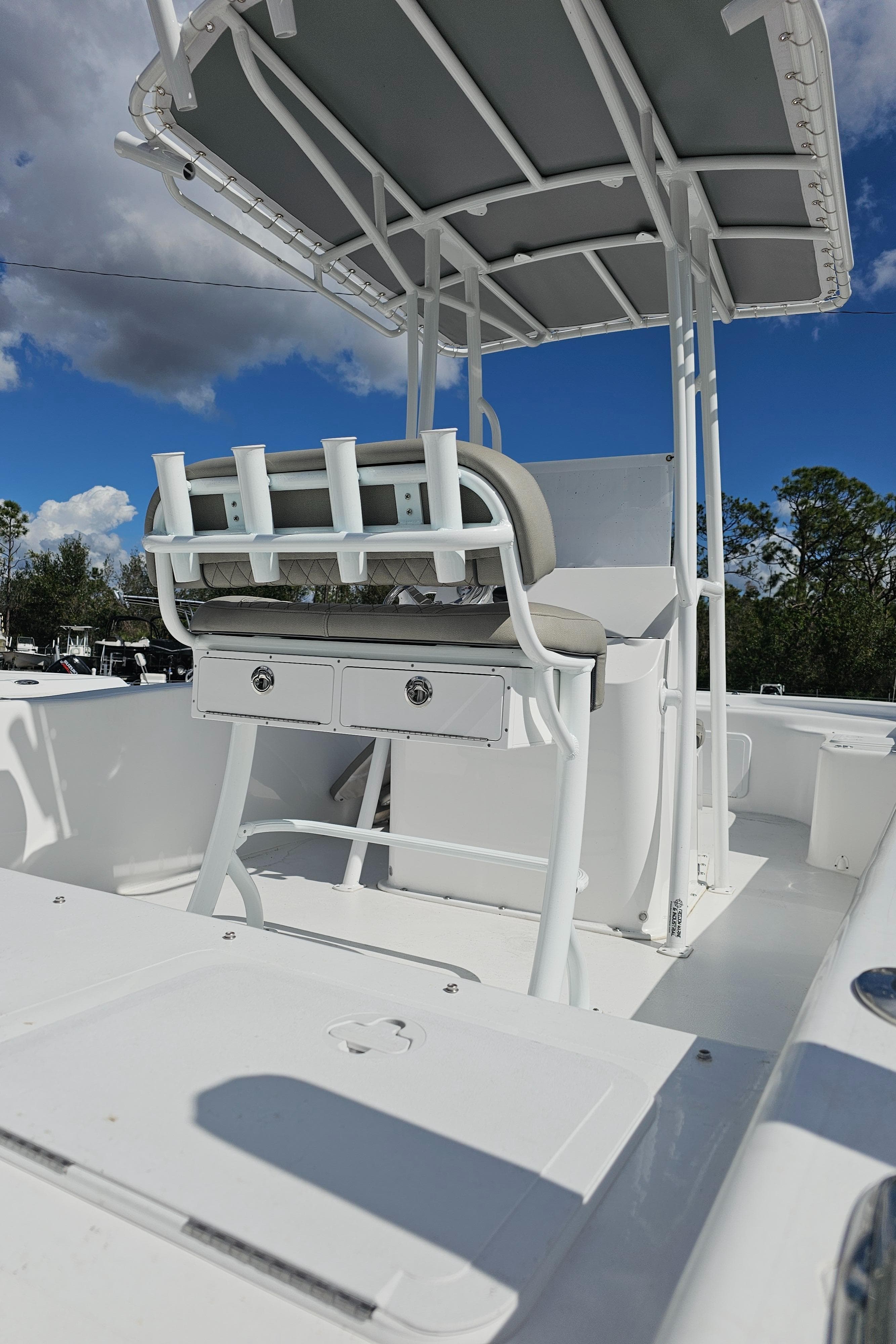 2025 Savannah SS21 boat interior with seating and canopy under a clear blue sky.
