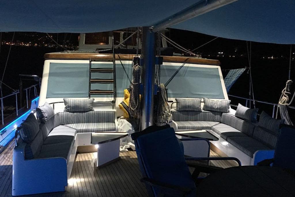 Luxurious 1994 Custom GULET yacht deck with elegant seating and ambient lighting at night.