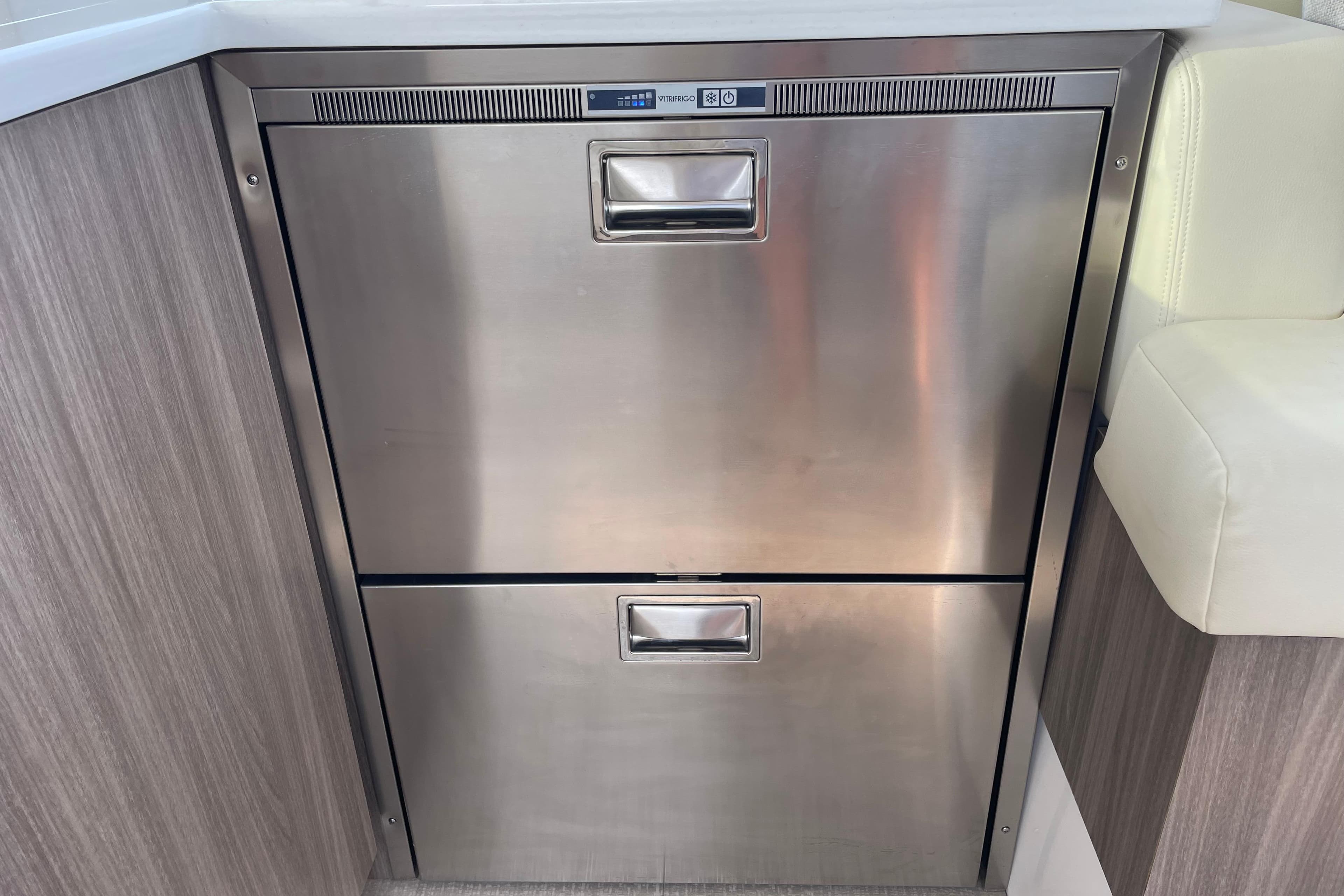 Stainless steel refrigerator drawers on 2022 Regal 38 Grande Coupe yacht interior.