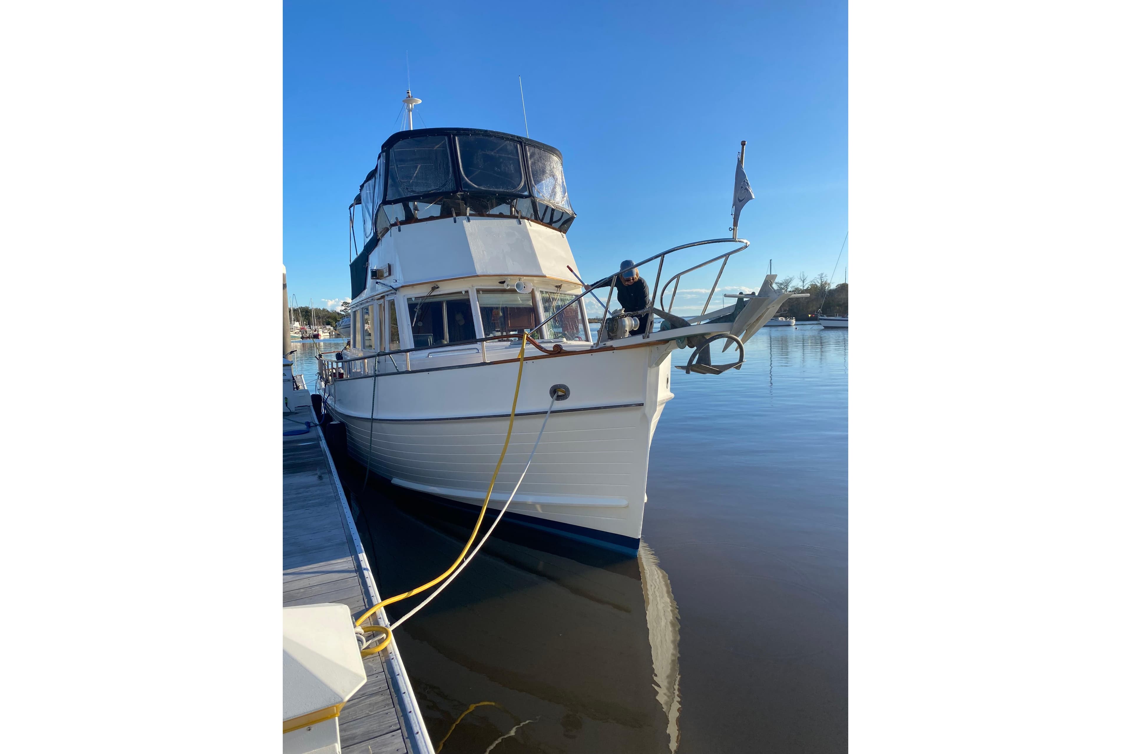 1991 Grand Banks 42 Classic yacht docked at marina under clear blue sky.