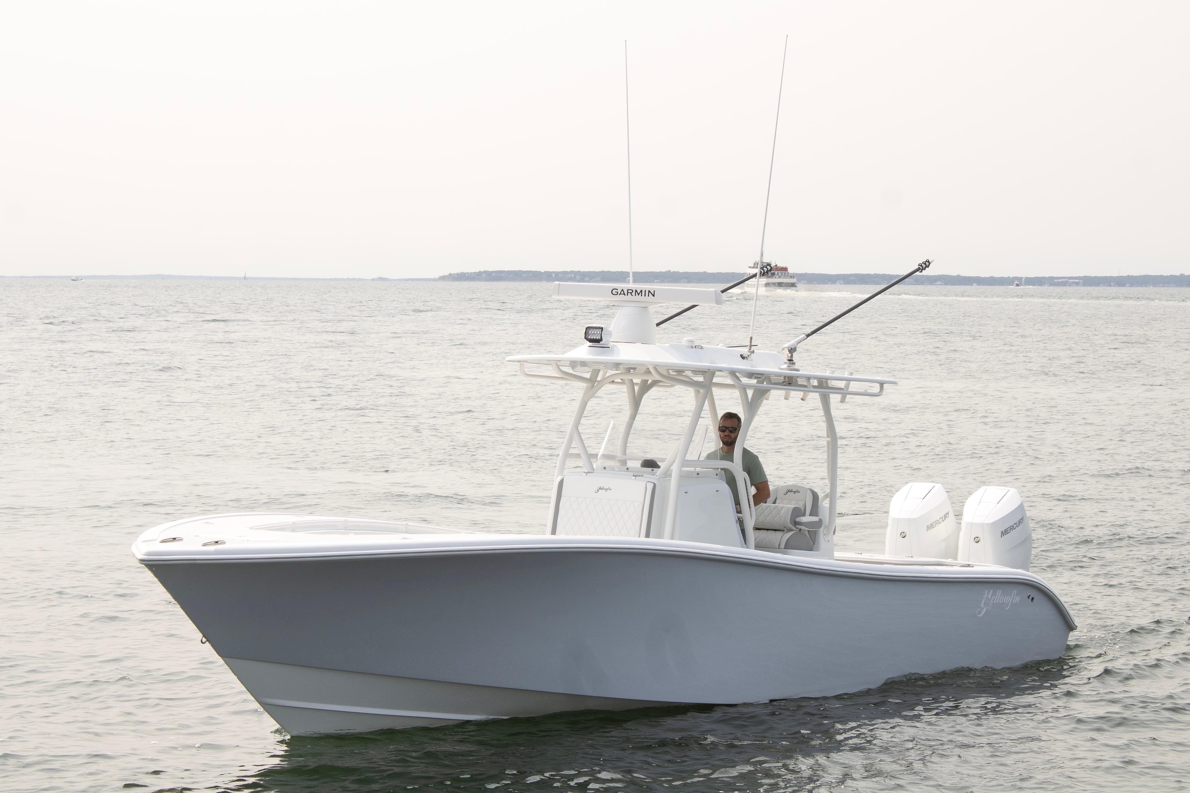 2025 Yellowfin 32 Offshore boat on open water, featuring dual engines and sleek design.