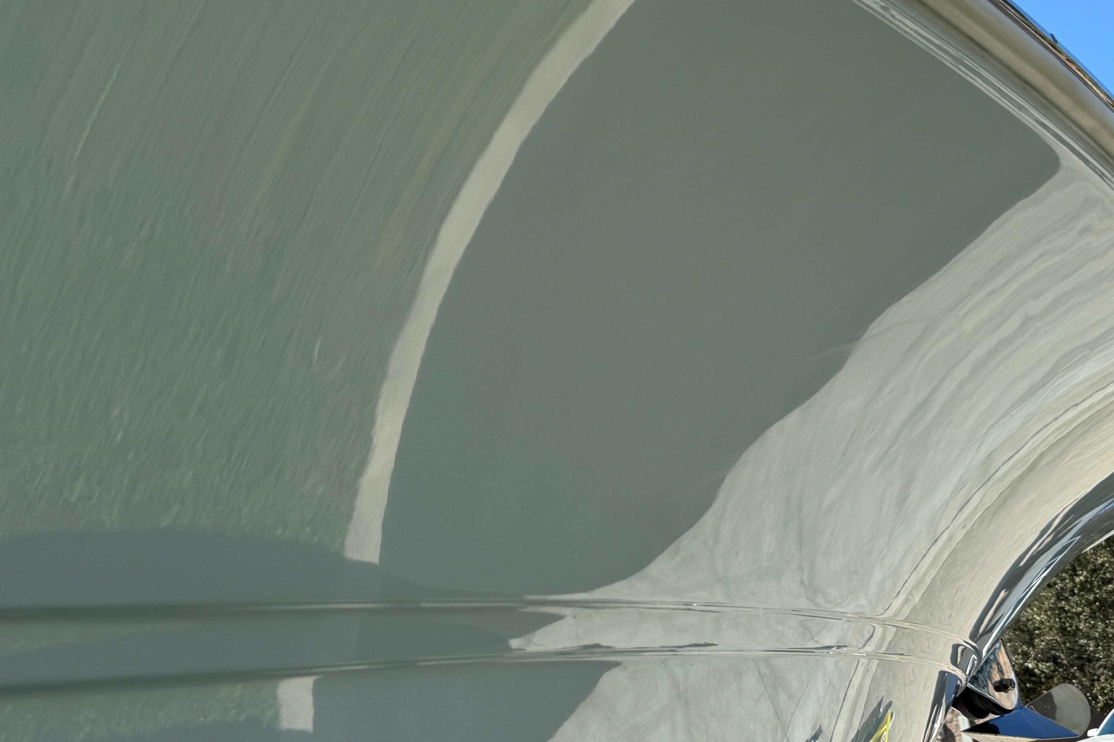Close-up of 2025 Sea Fox 288 Commander boat hull with reflective surface.