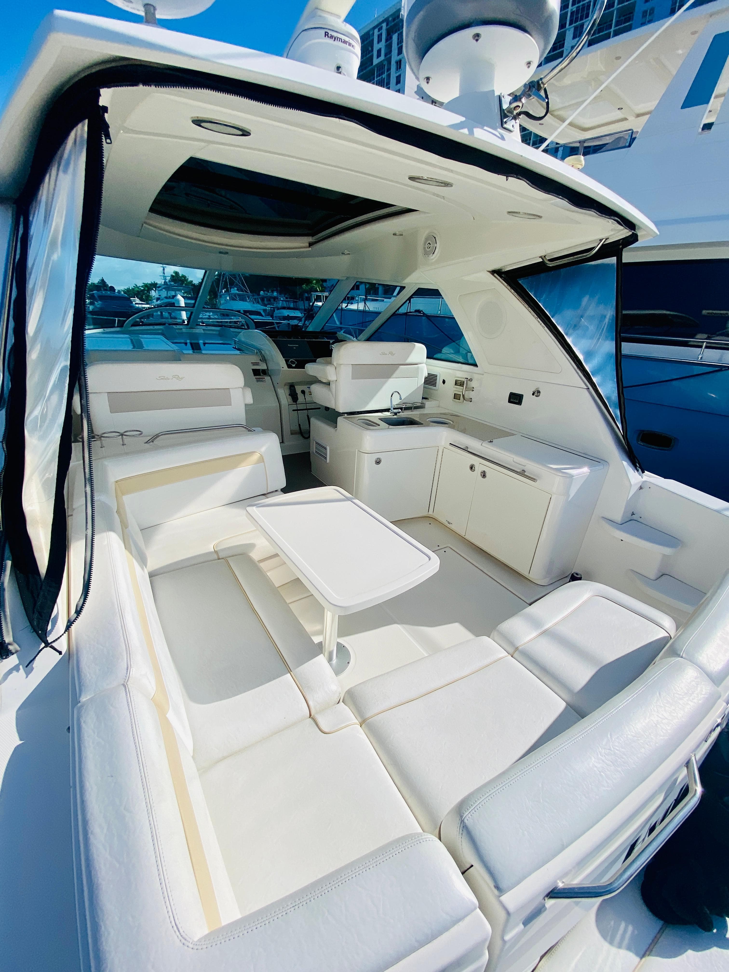 2010 Sea Ray 450 Sundancer yacht interior with white seating and table.