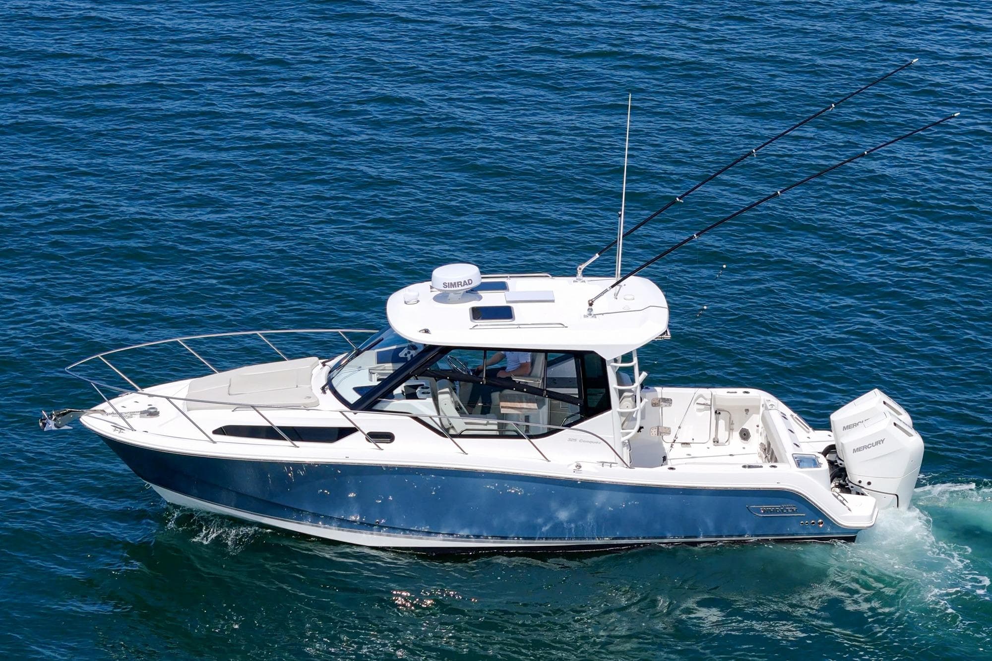 2024 Boston Whaler 325 Conquest cruising on blue ocean waters.