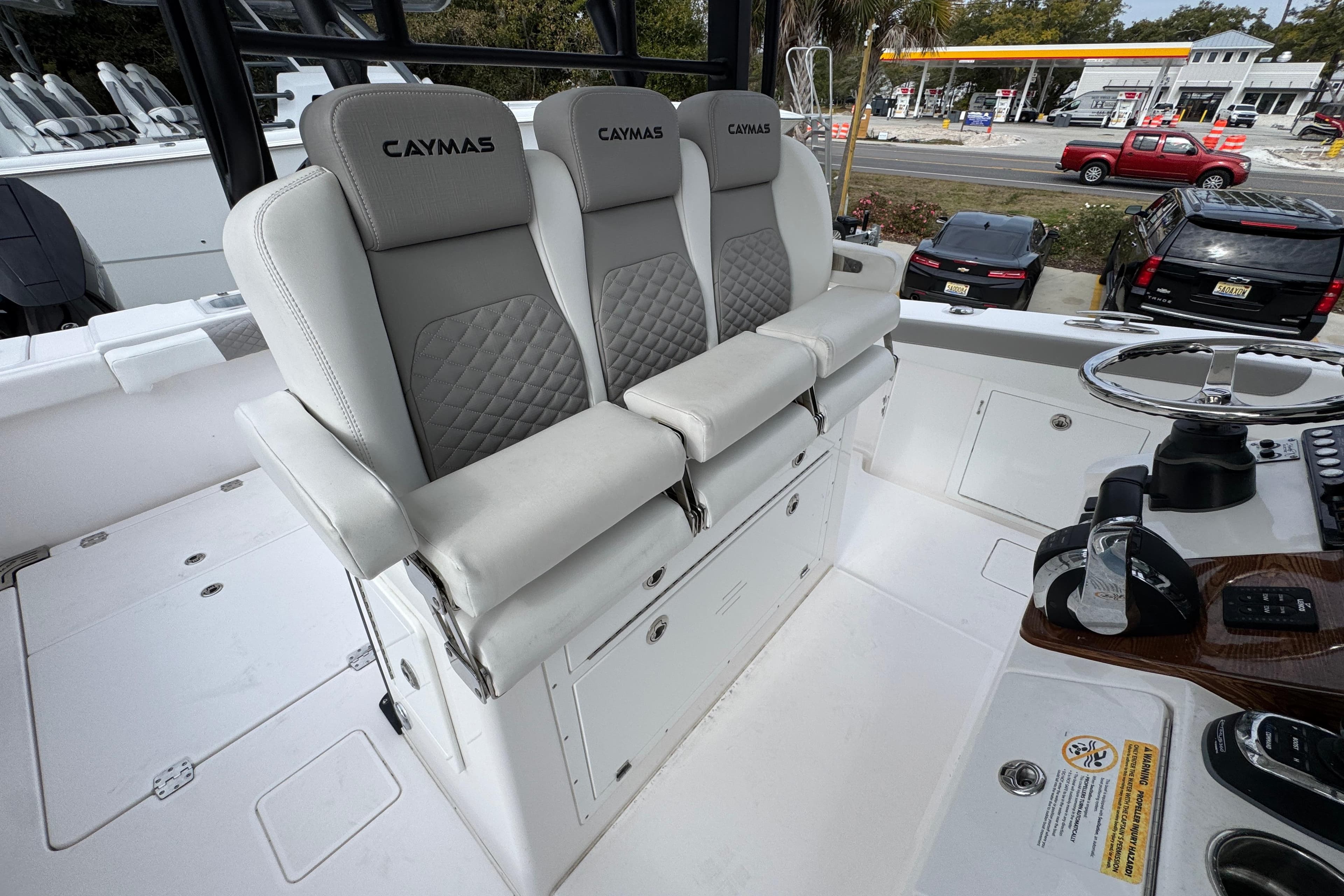2024 Caymas 34 CT boat interior with three cushioned seats and steering console.