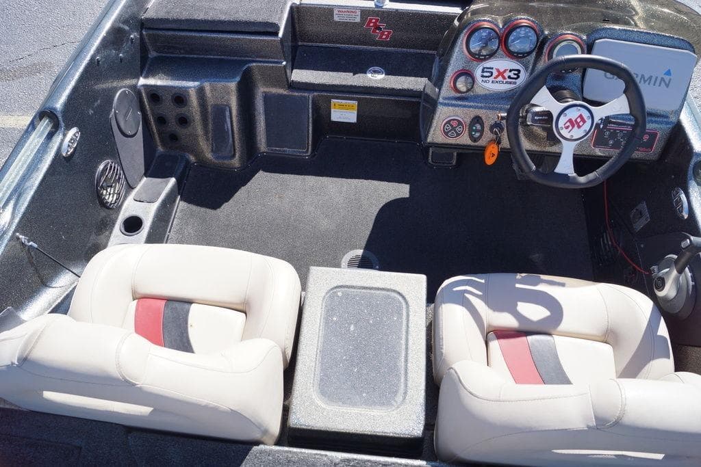 2010 Bass Cat Cougar boat interior with steering wheel and dashboard controls.