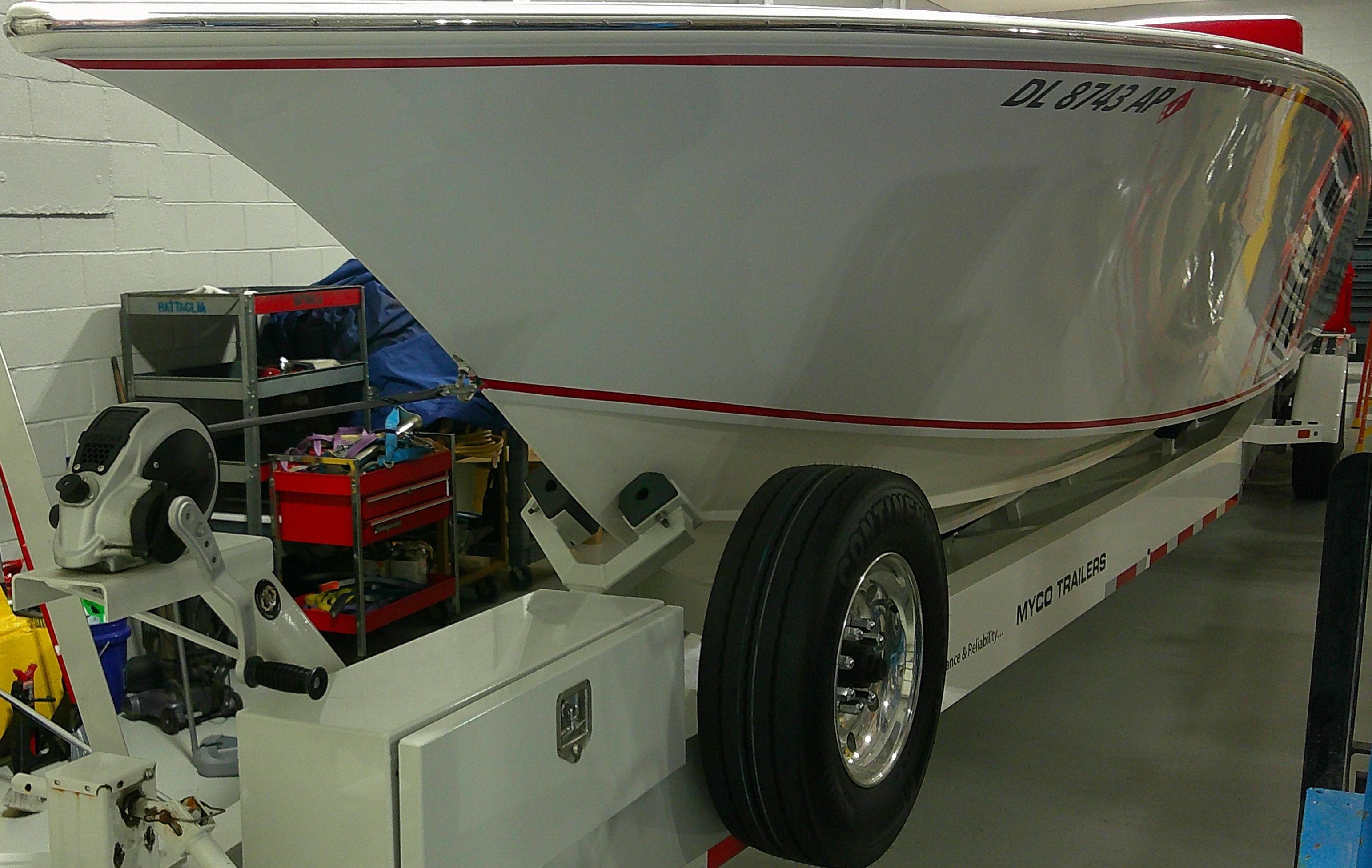 1993 Fountain 47 boat on trailer in garage setting.