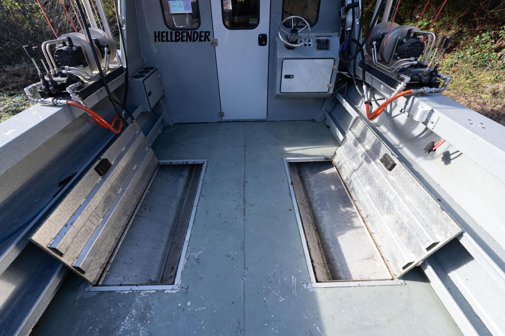 Interior of 2021 KingFisher 2825 Coastal Express boat with storage compartments and equipment.