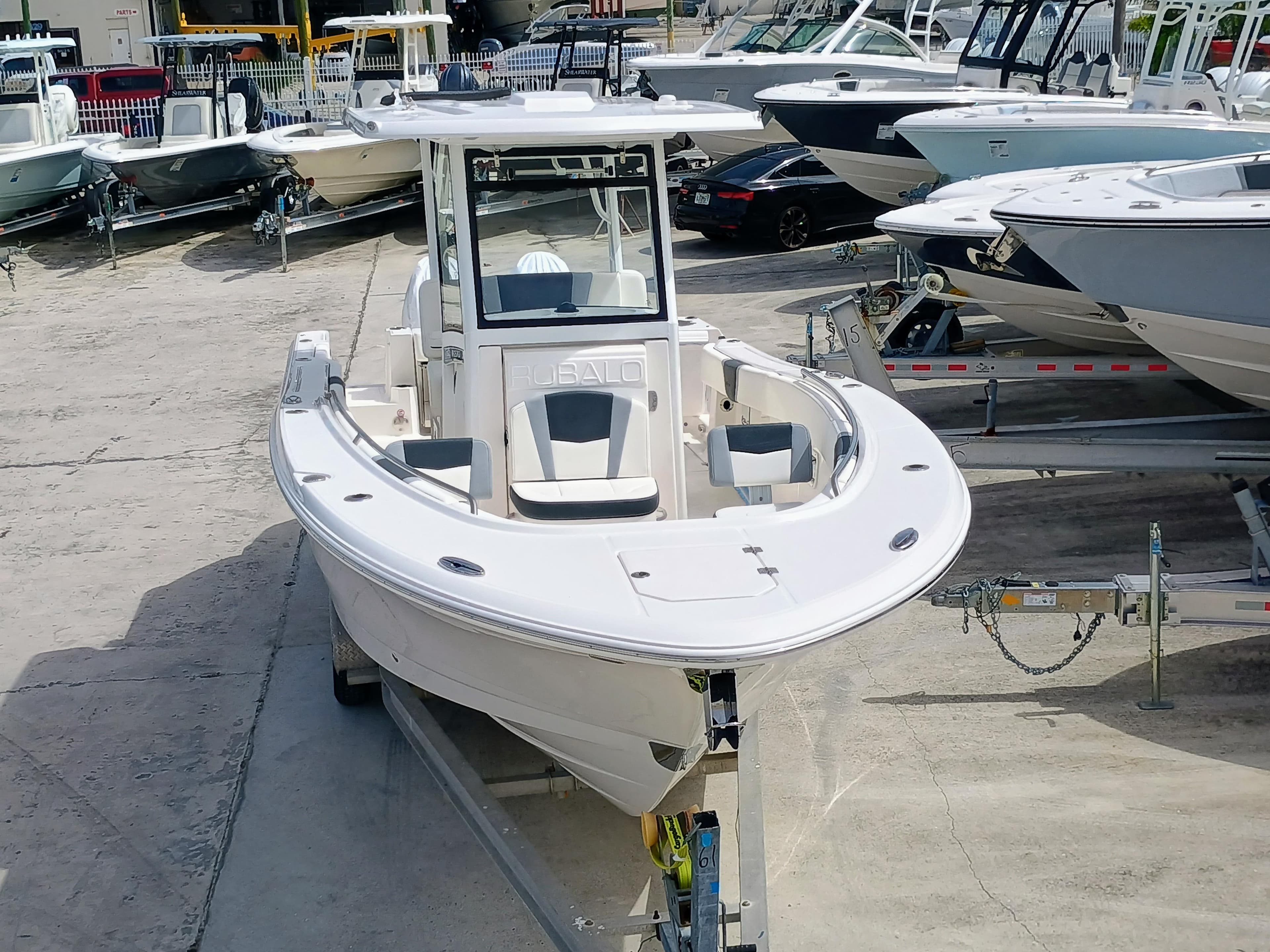 2025 Robalo R270 Center Console boat on trailer in marina setting.