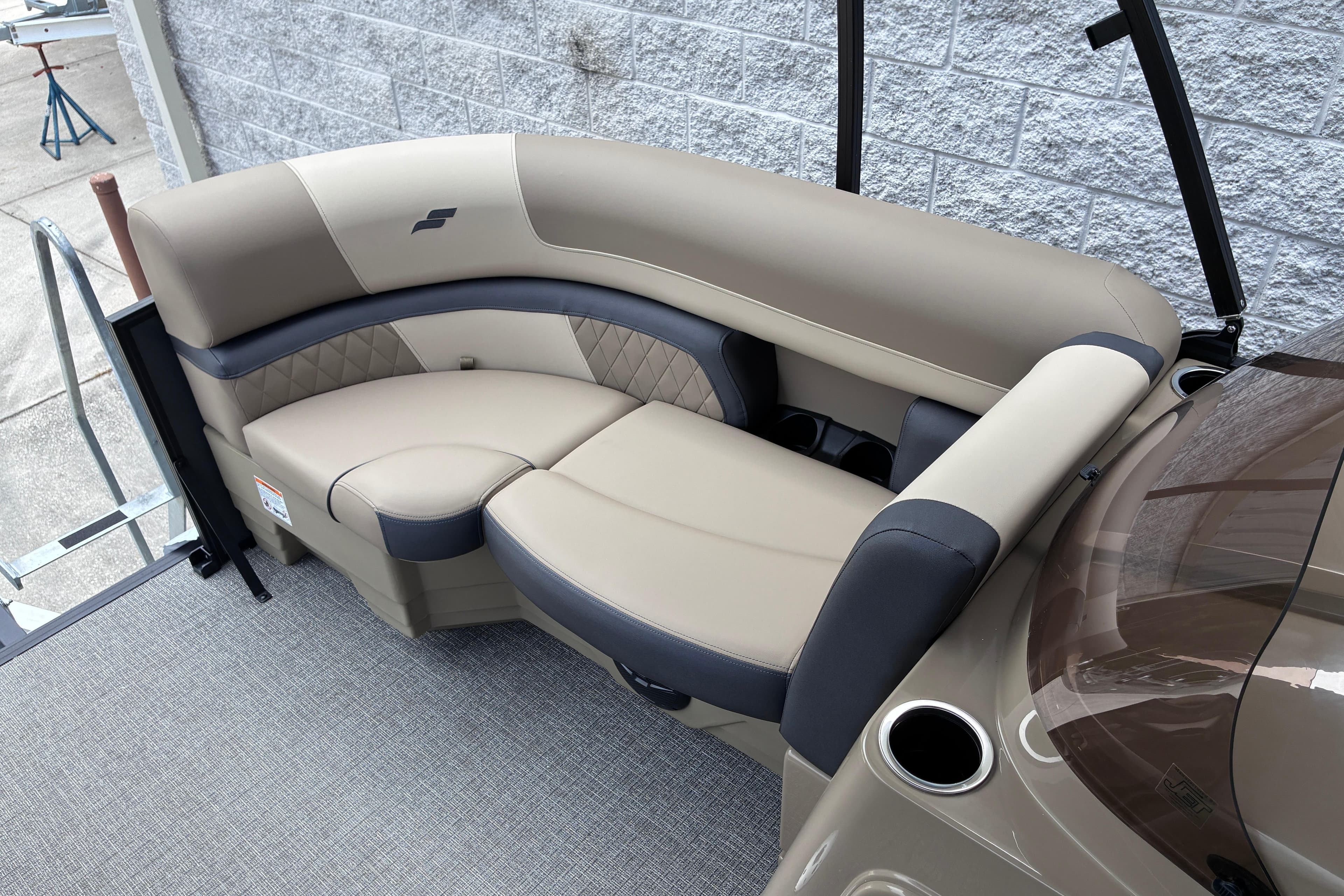 Luxurious seating on 2026 Starcraft EXS 1 Q DH boat, featuring beige and black upholstery.