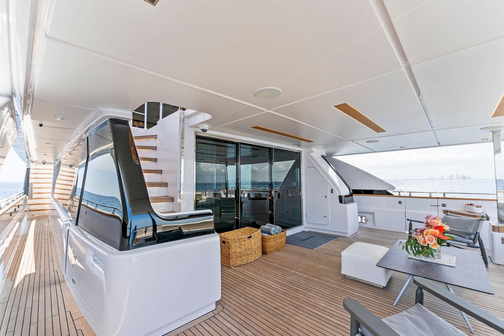 Luxurious 2024 Custom Line Navetta 33 yacht deck with modern seating and ocean view.