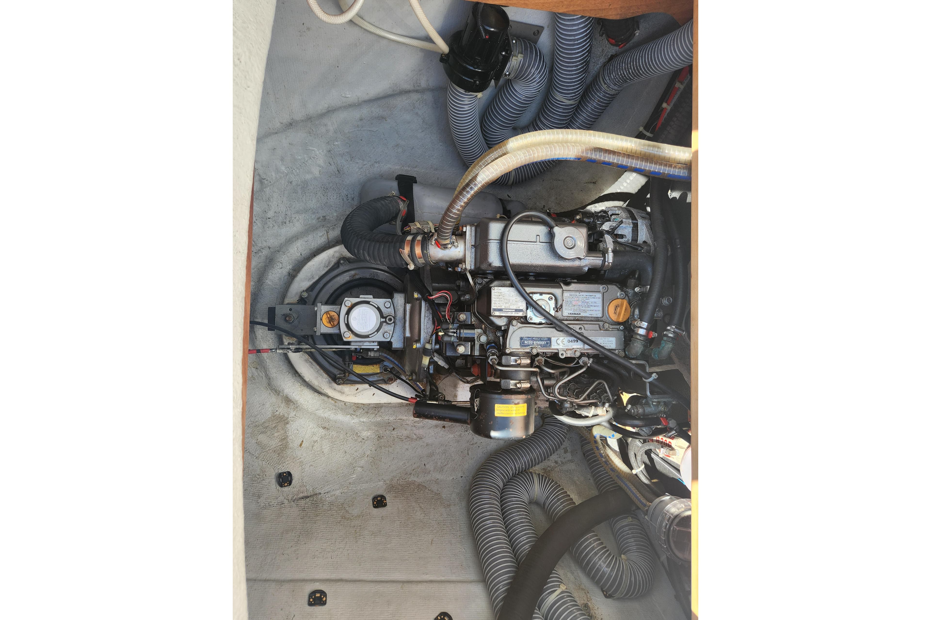 Engine compartment of a 2019 Lagoon 380 catamaran, showcasing detailed mechanical components.