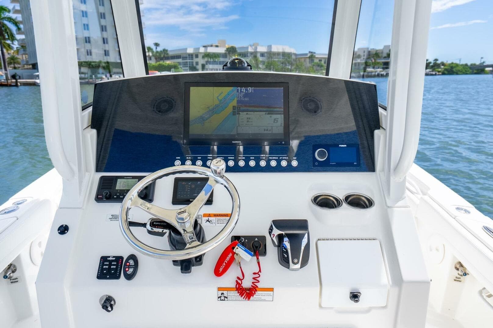 2021 Regulator 26XO boat dashboard with steering wheel and navigation display.