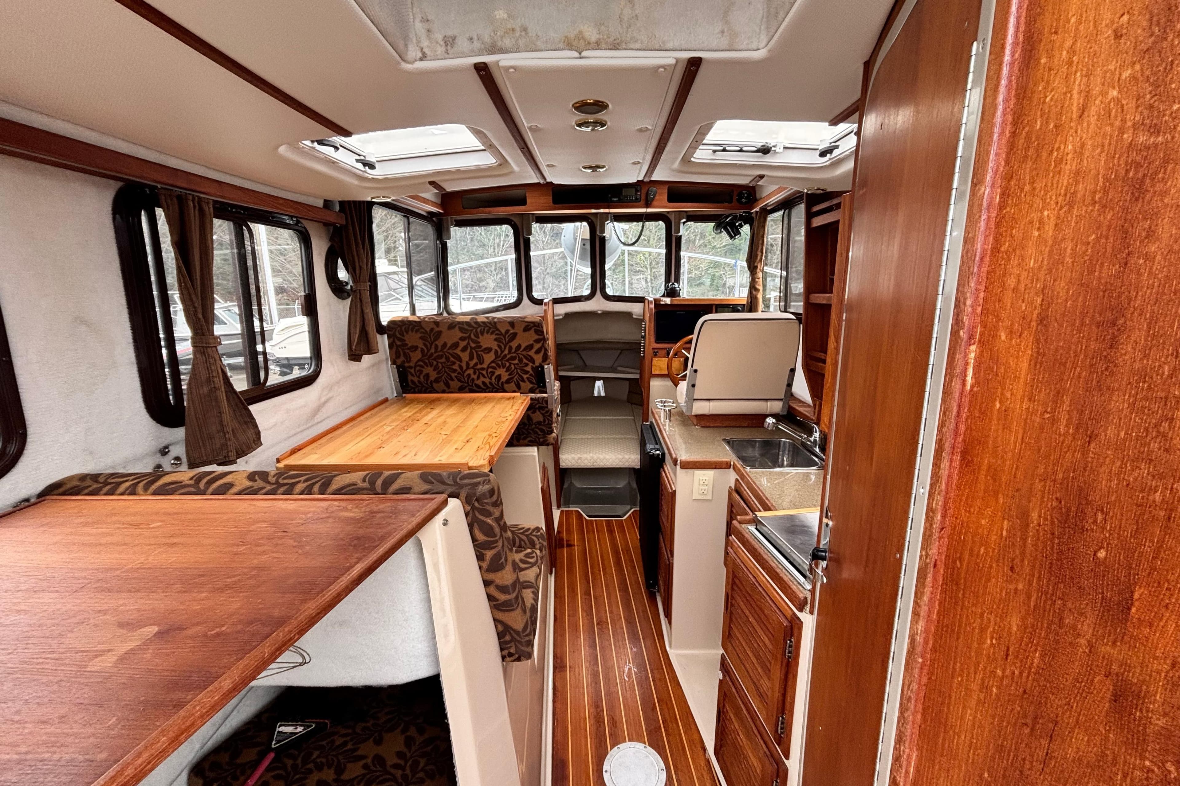 Interior of a 2010 Ranger Tugs R-25 SC with wood finish.