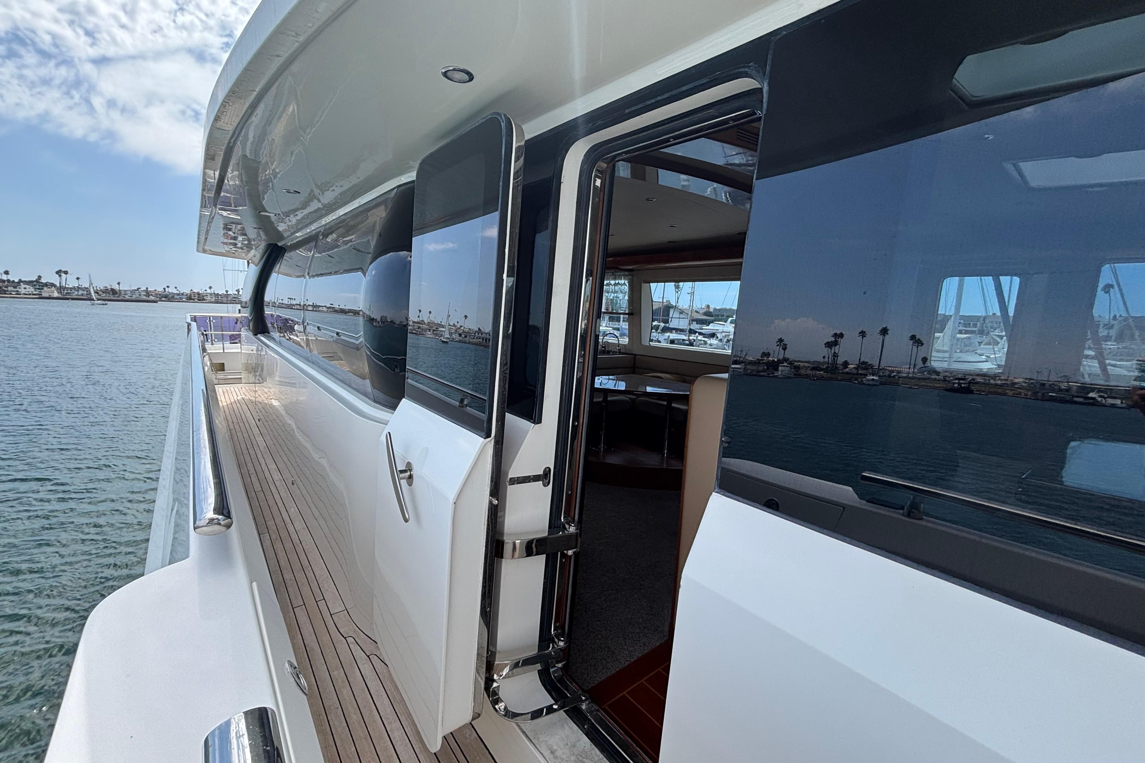 Norseman 80 yacht, 2010 model, featuring sleek exterior and open cabin door by the water.