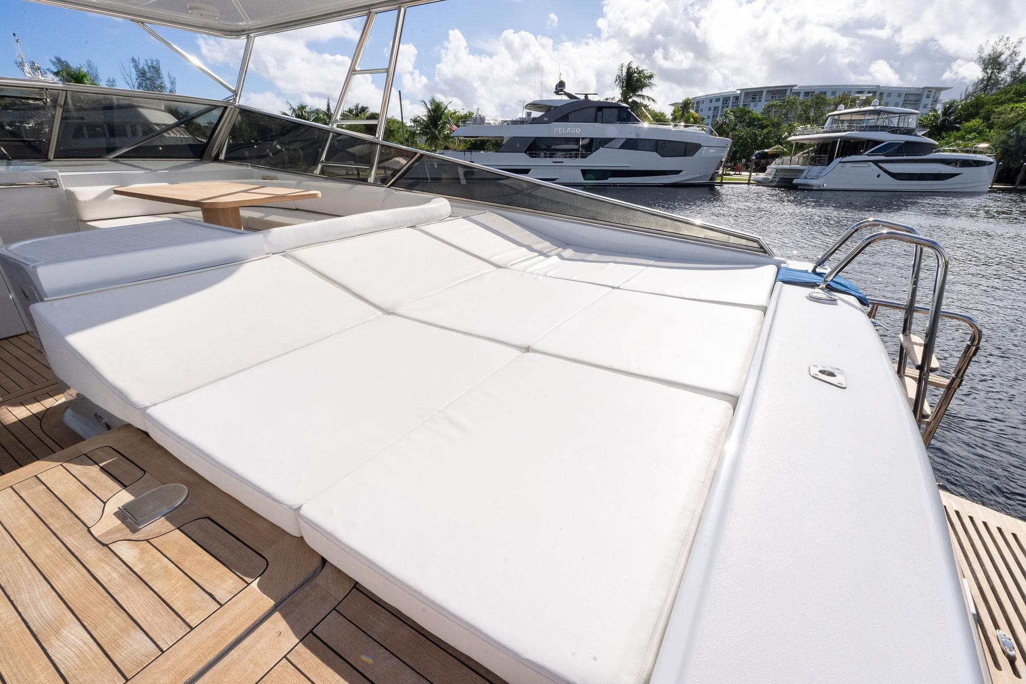 Luxurious 1995 Itama 46 yacht with spacious sunbathing deck and scenic marina view.