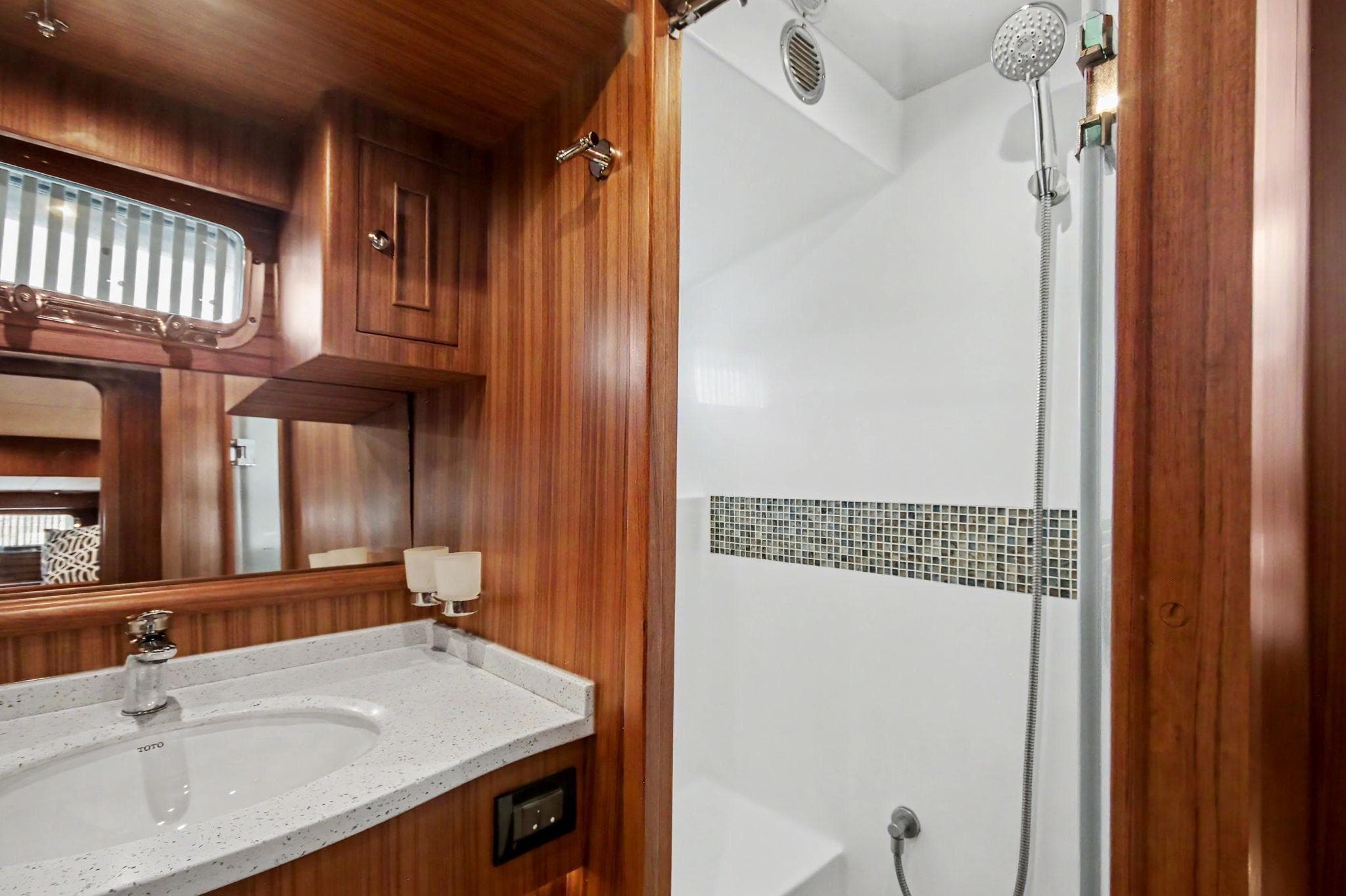 Luxurious bathroom in 2022 North Pacific 45 Pilothouse yacht with wood accents and modern fixtures.