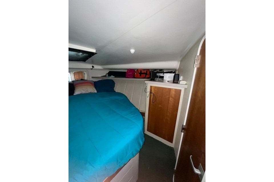 1994 Mainship 40 Sedan Bridge cabin interior with bed and storage.