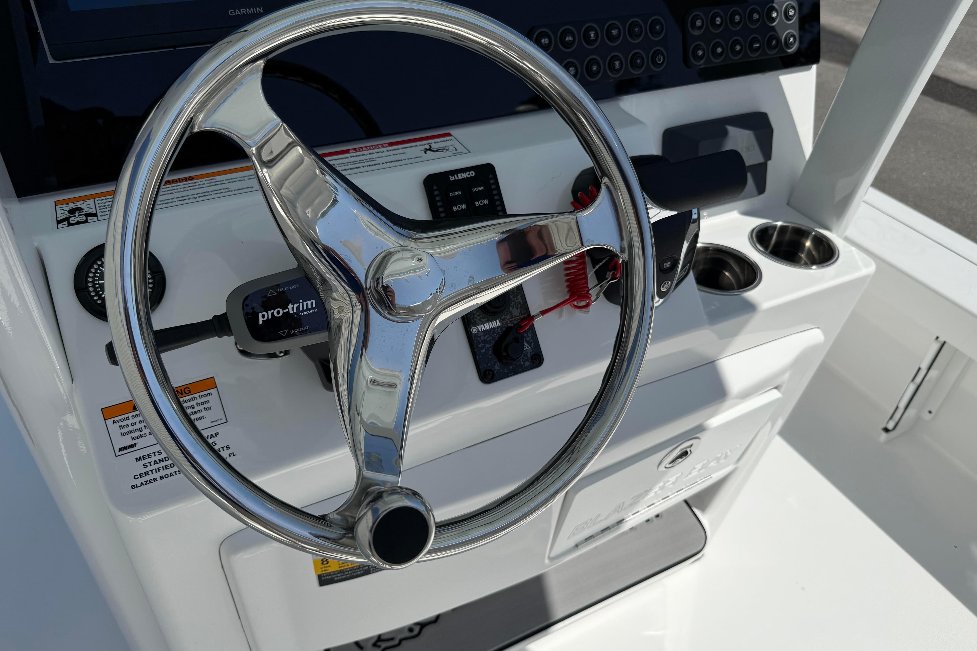 2026 Blazer 2550 GTS boat steering console with modern controls and cup holders.
