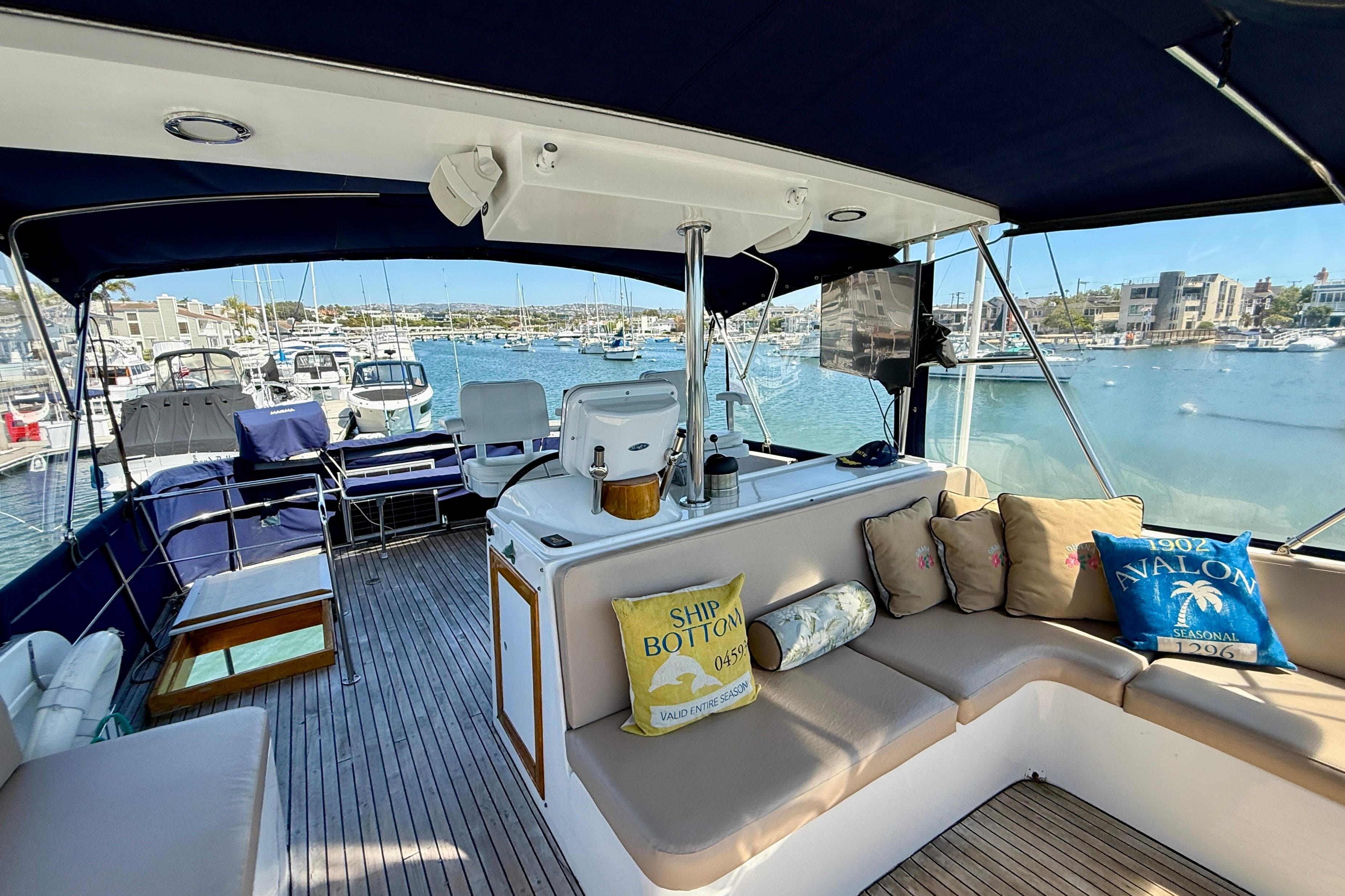 1991 Kong & Halvorsen Island Gypsy yacht interior with seating, cushions, and marina view.