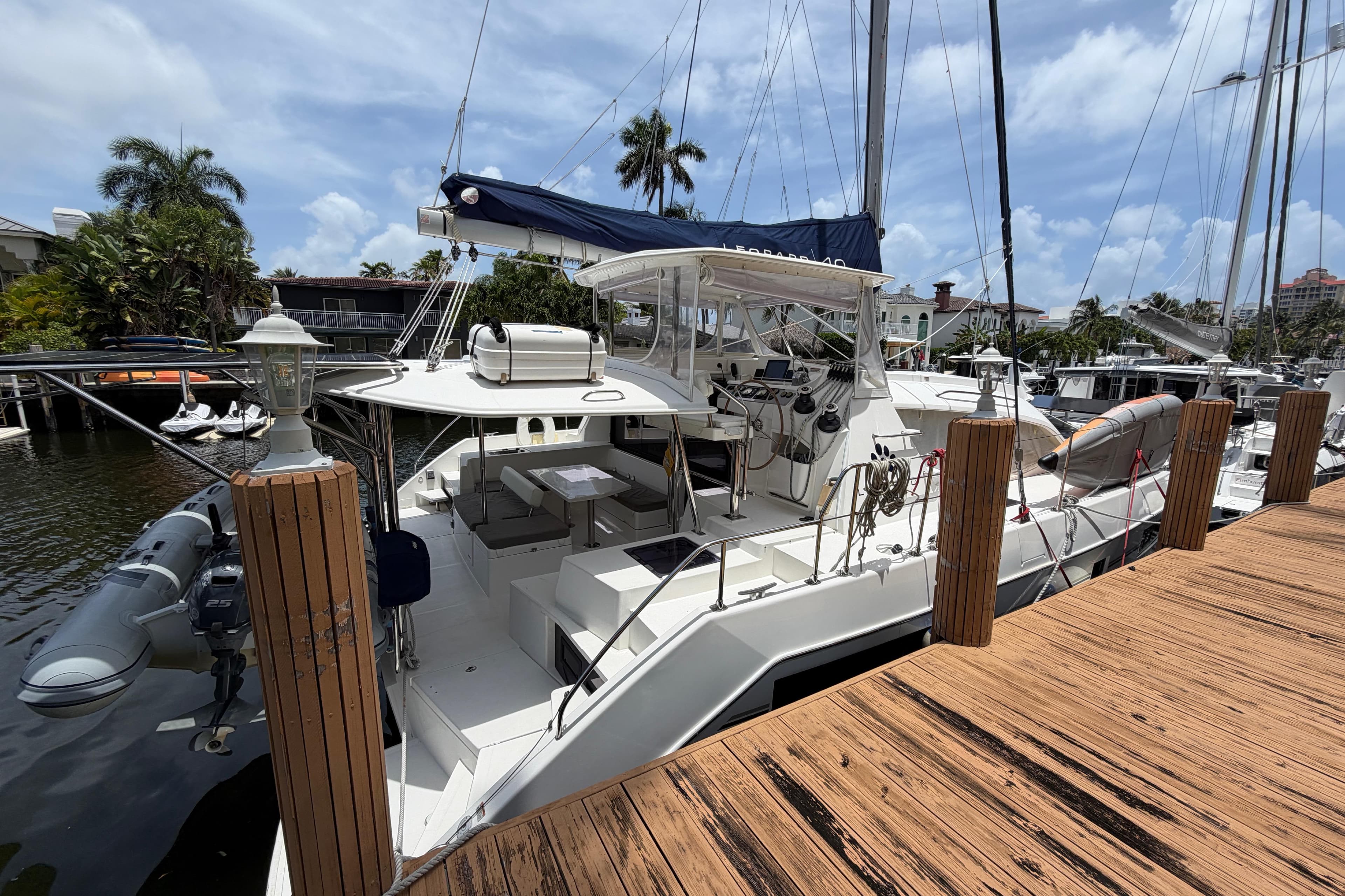2020 Leopard 40 catamaran docked at marina, featuring spacious deck and modern design.
