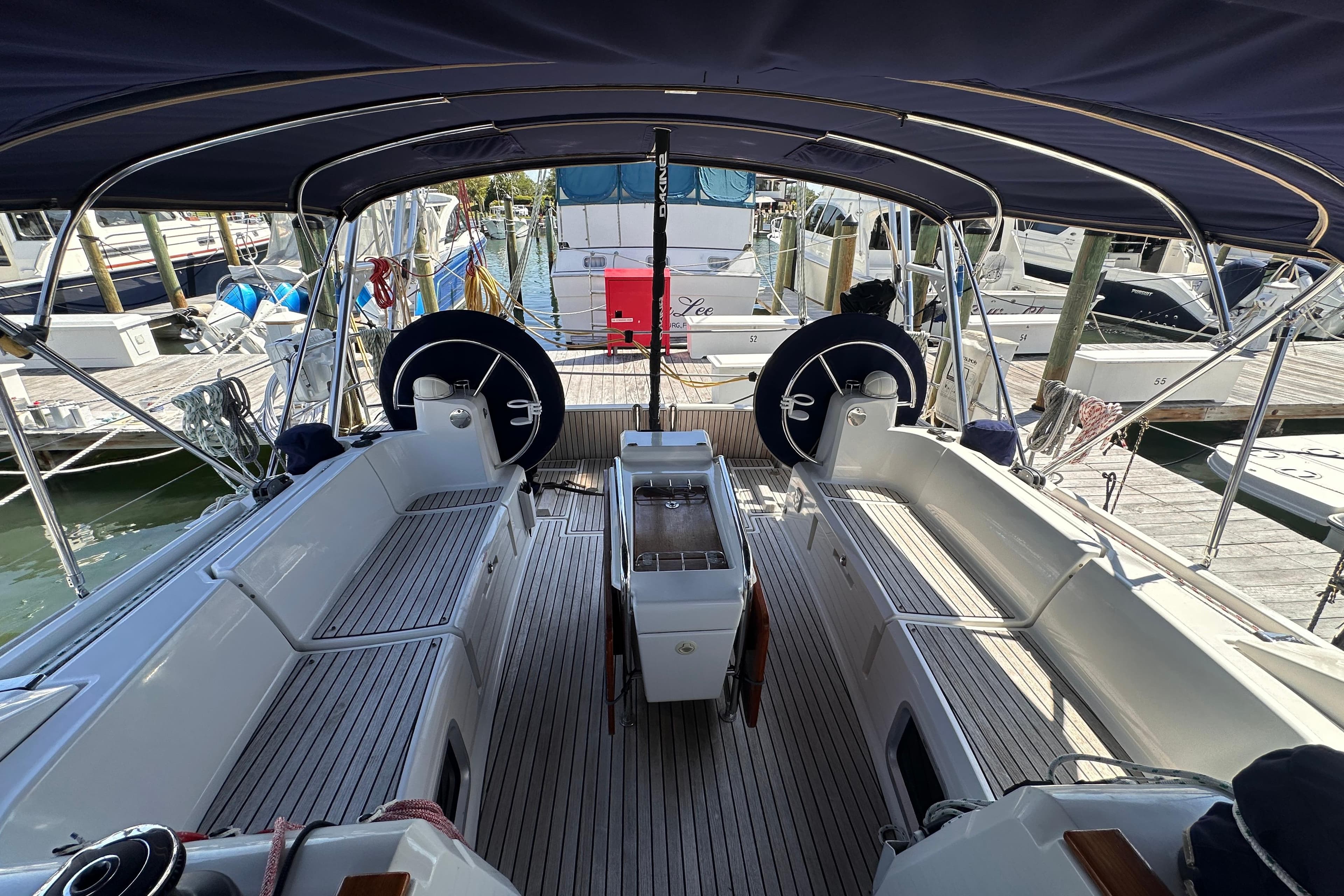 Cockpit view of 2015 Jeanneau Sun Odyssey 469 sailboat docked at marina.