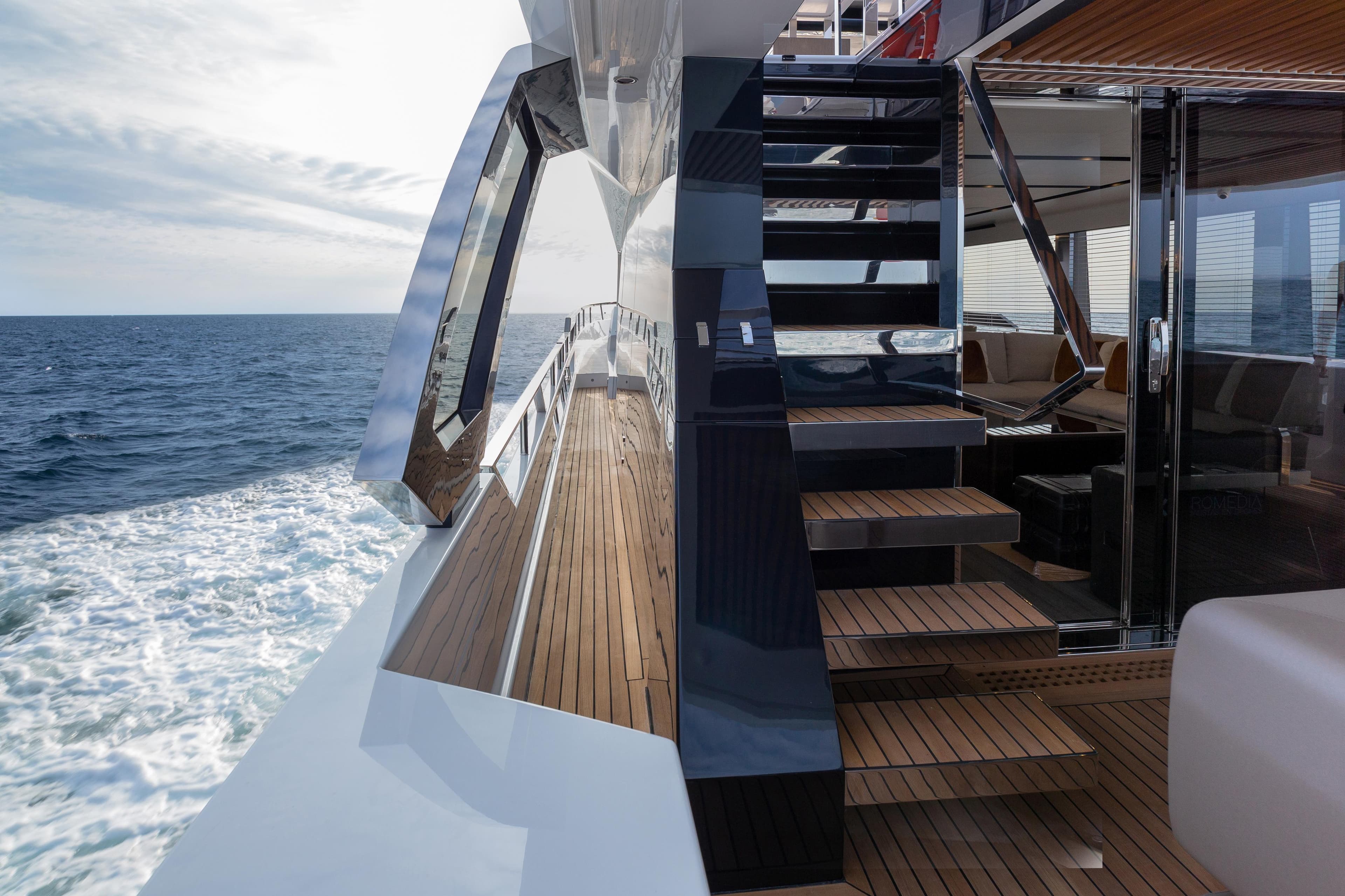 2023 Astondoa AS8 Flybridge yacht, sleek deck and staircase, ocean view.