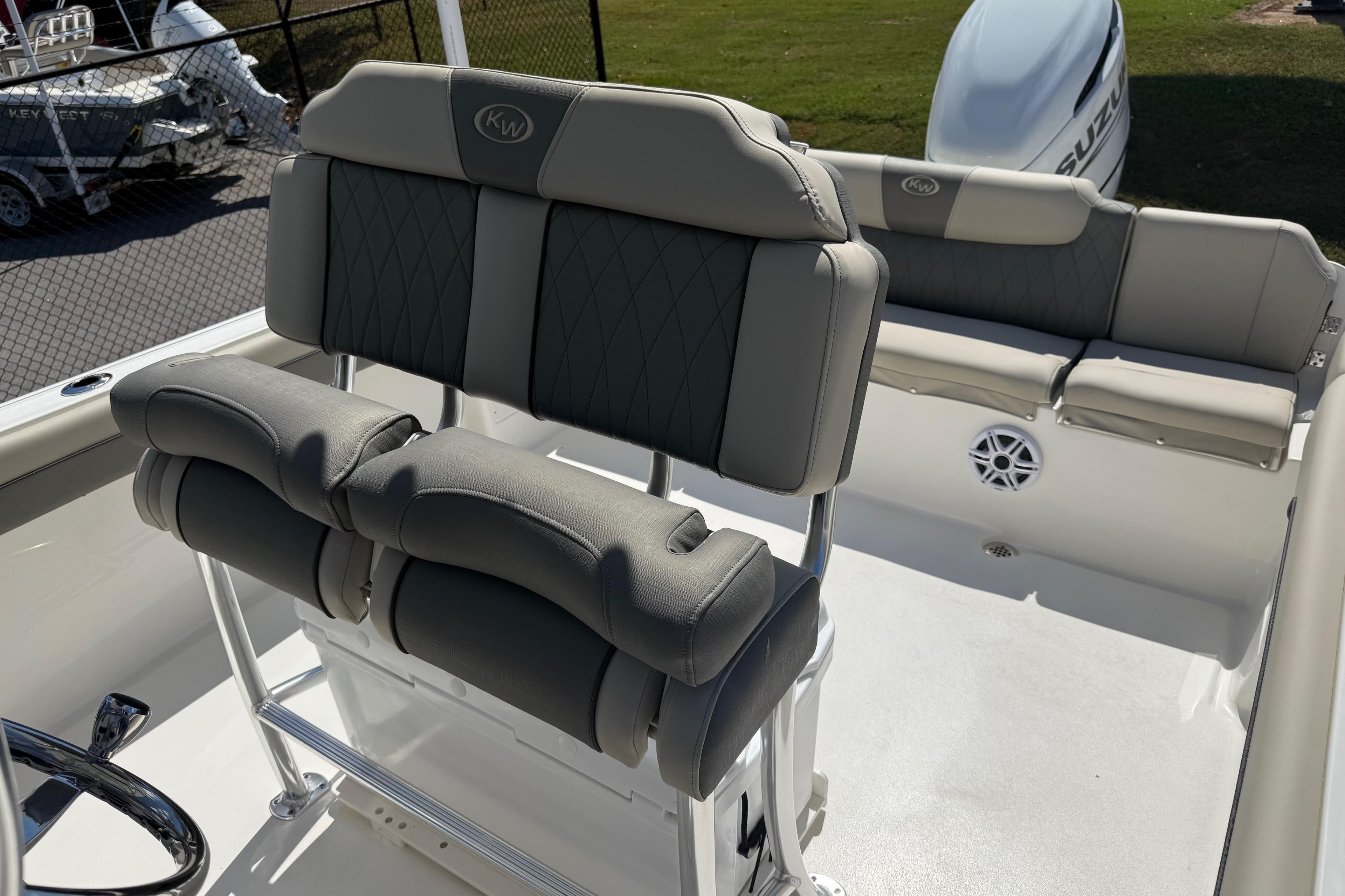 2026 Key West 239 FS boat interior with cushioned seating and steering wheel.