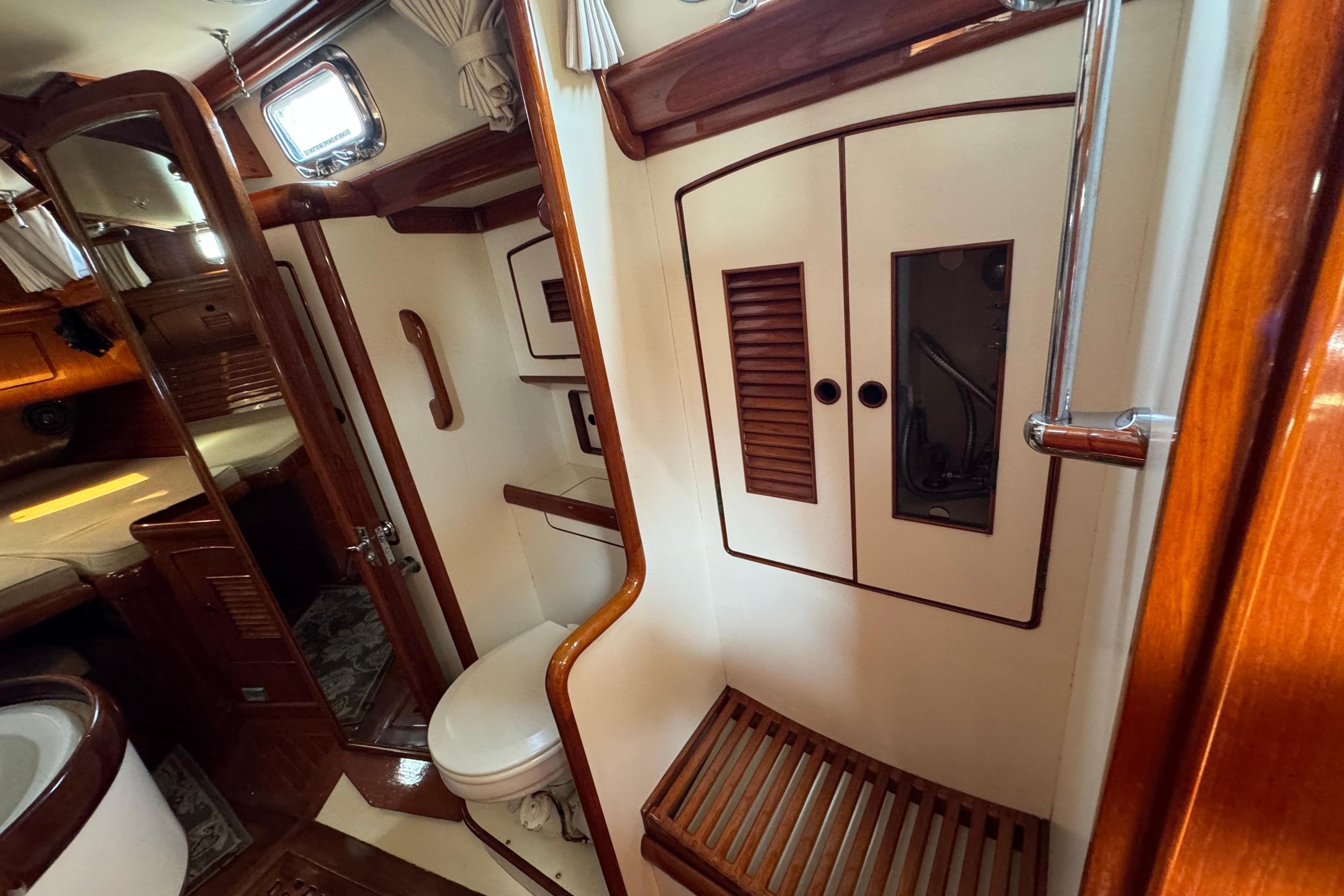 Interior of 1986 Little Harbor 46 Center Cockpit yacht, featuring wood accents and compact bathroom.