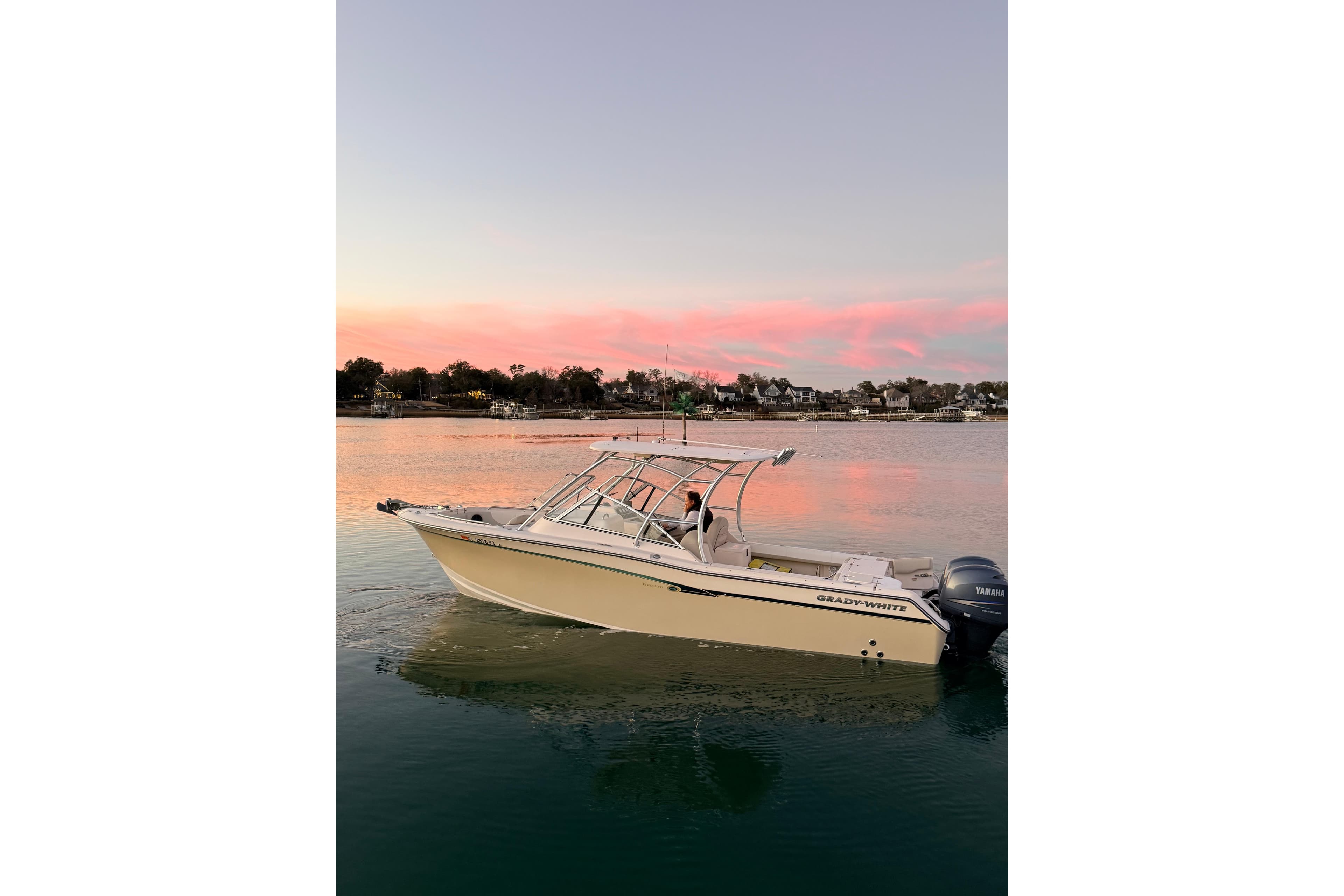 2012 Grady-White Freedom 275 boat on calm water at sunset.