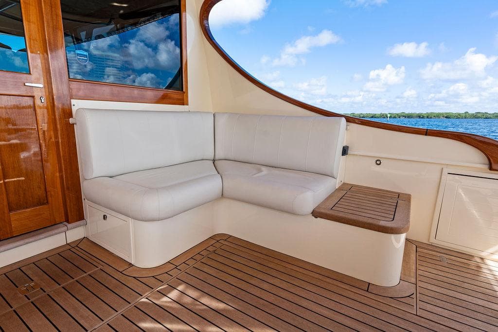 Luxurious seating area on 2018 Palm Beach Motor Yachts PB55 Flybridge with ocean view.