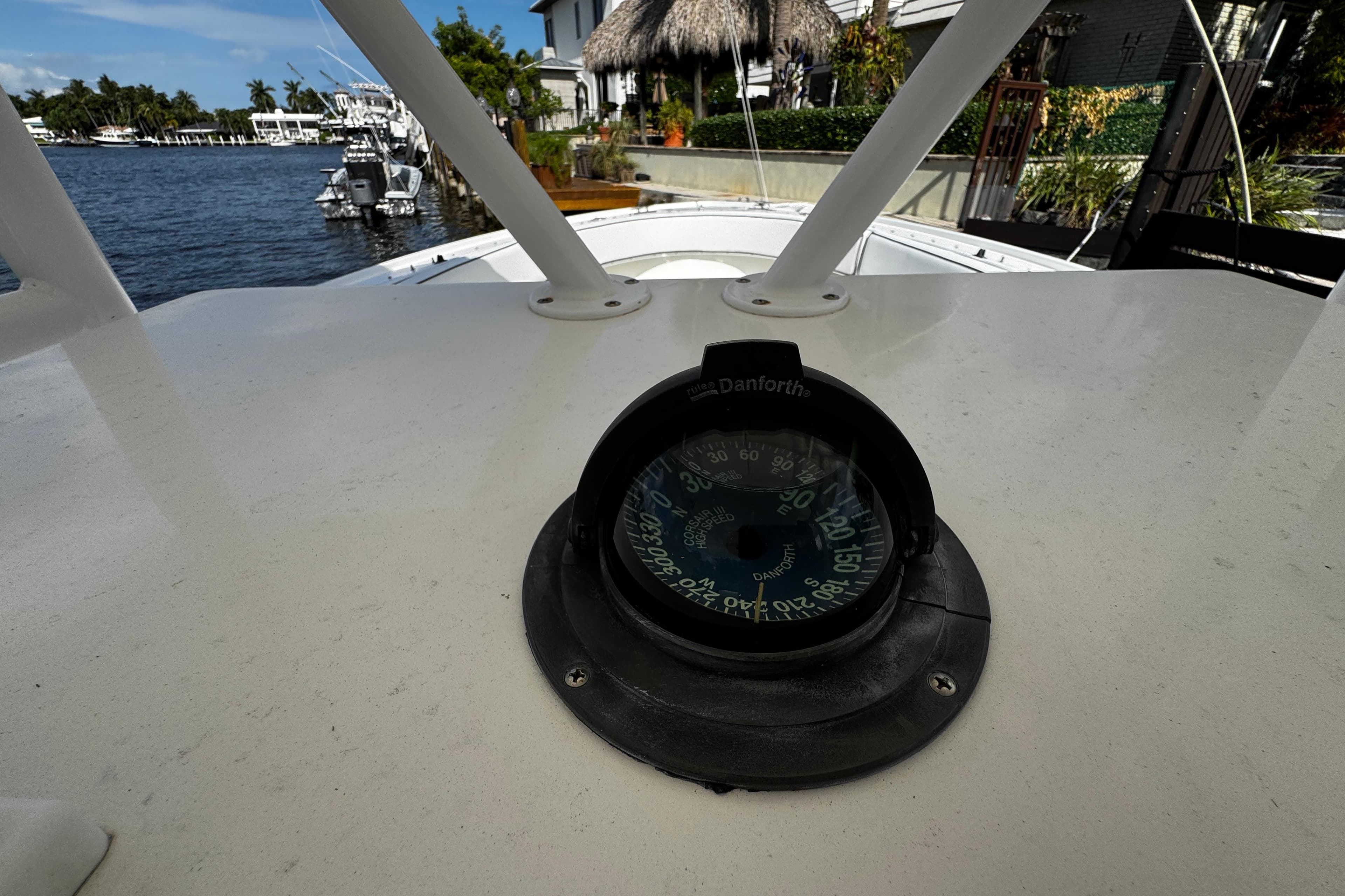 Compass on 2004 Dusky 33 boat, docked near waterfront homes.