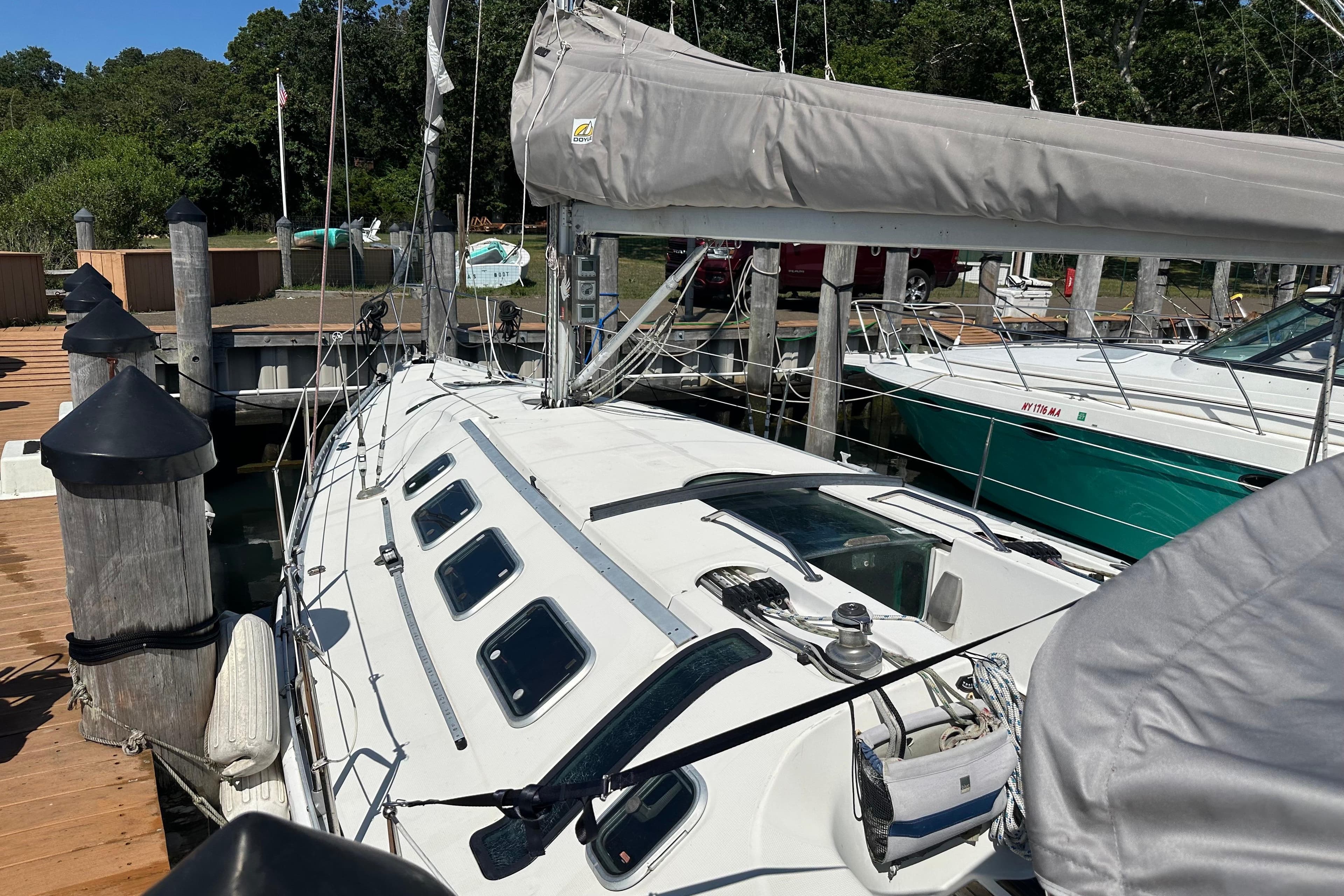1989 Beneteau First 41s5 sailboat docked at a marina, showcasing sleek design and rigging.