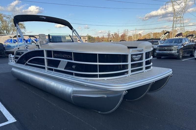 2026 Bennington M Quad Bench 22 MFB pontoon boat parked outdoors.
