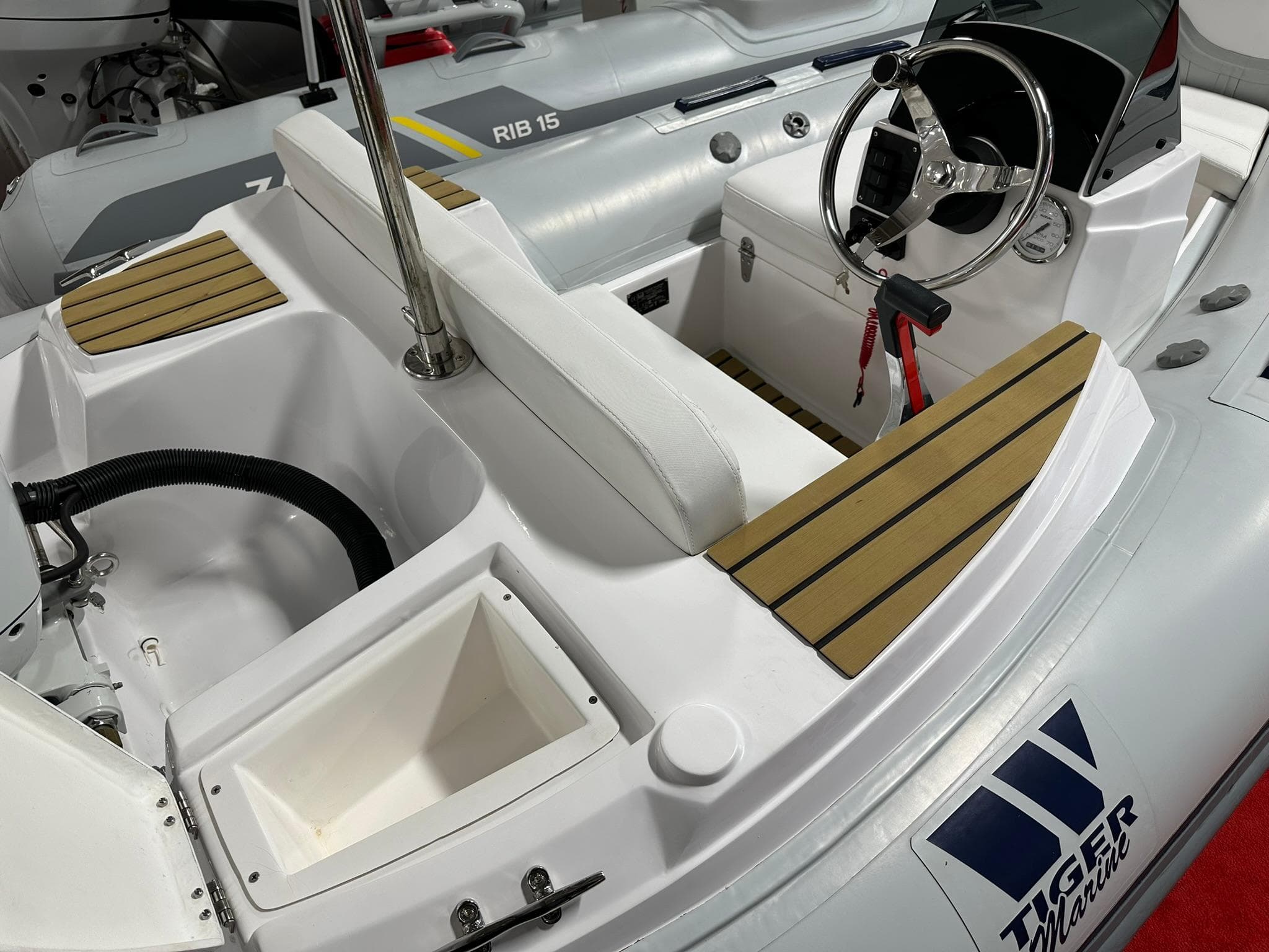 2024 Tiger Marine PT 340 boat interior with steering wheel and seating.