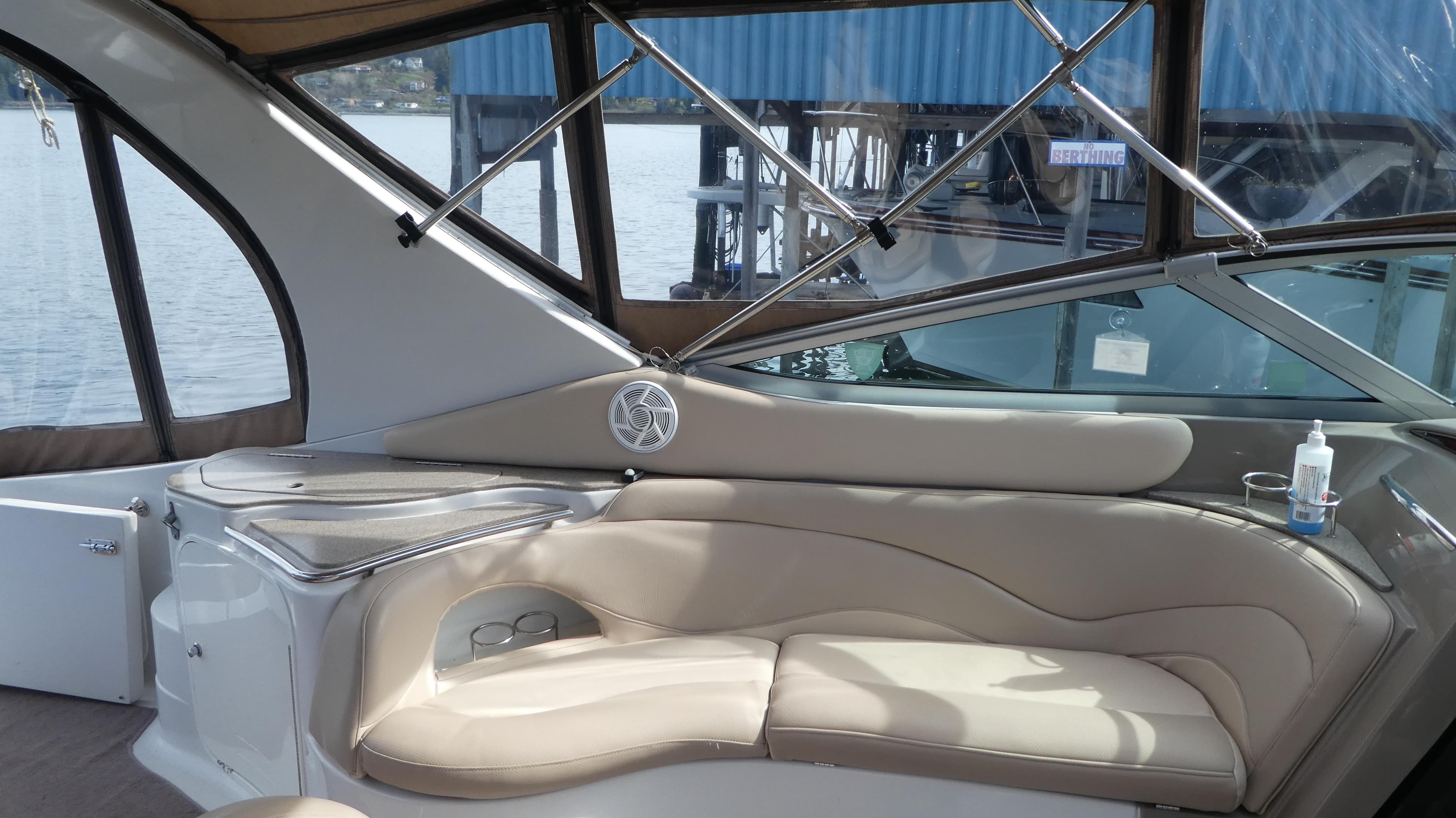 Interior of 2004 Larson 370 boat with beige seating and water view.